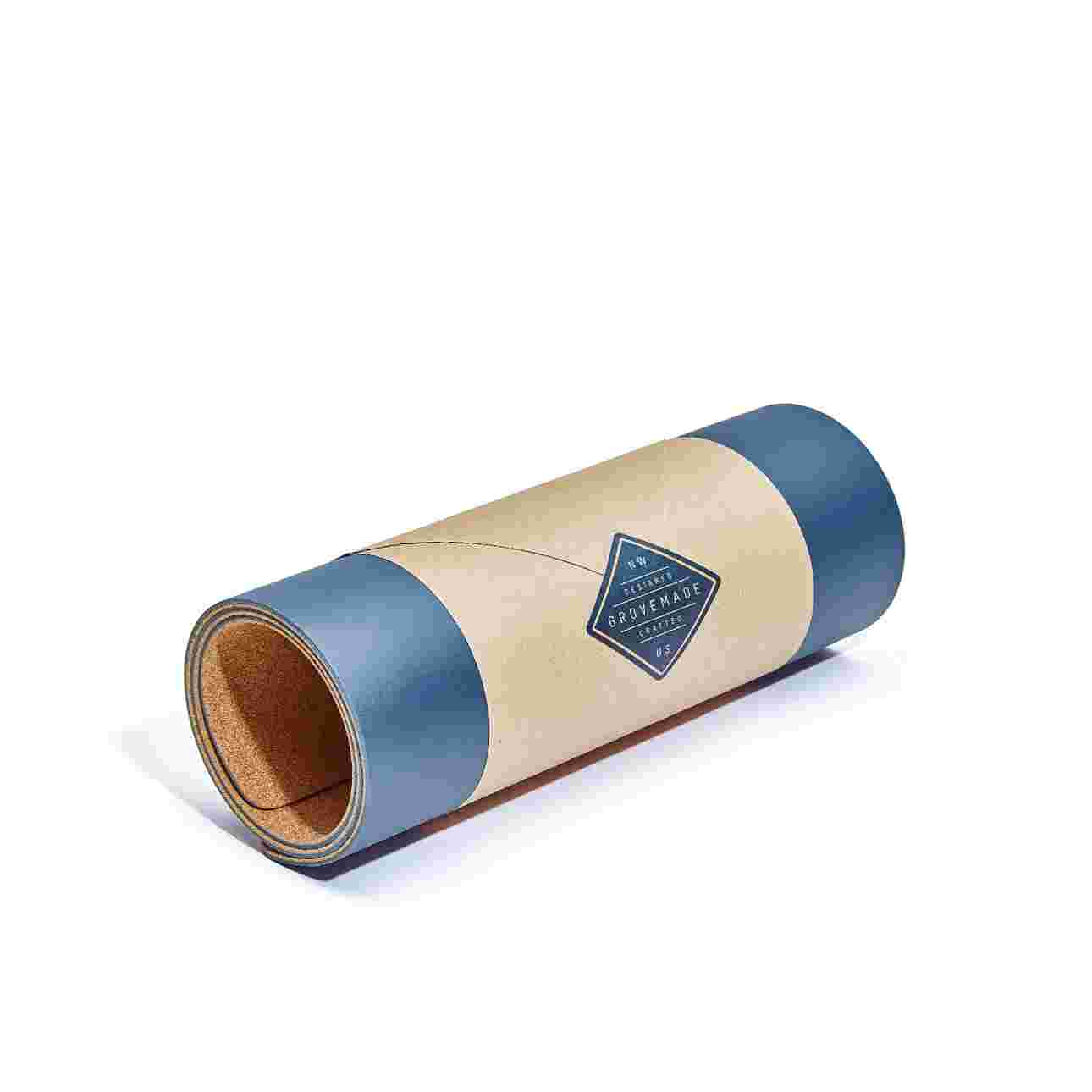 Small navy blue desk pad, rolled in brown craft paper for easy gifting.