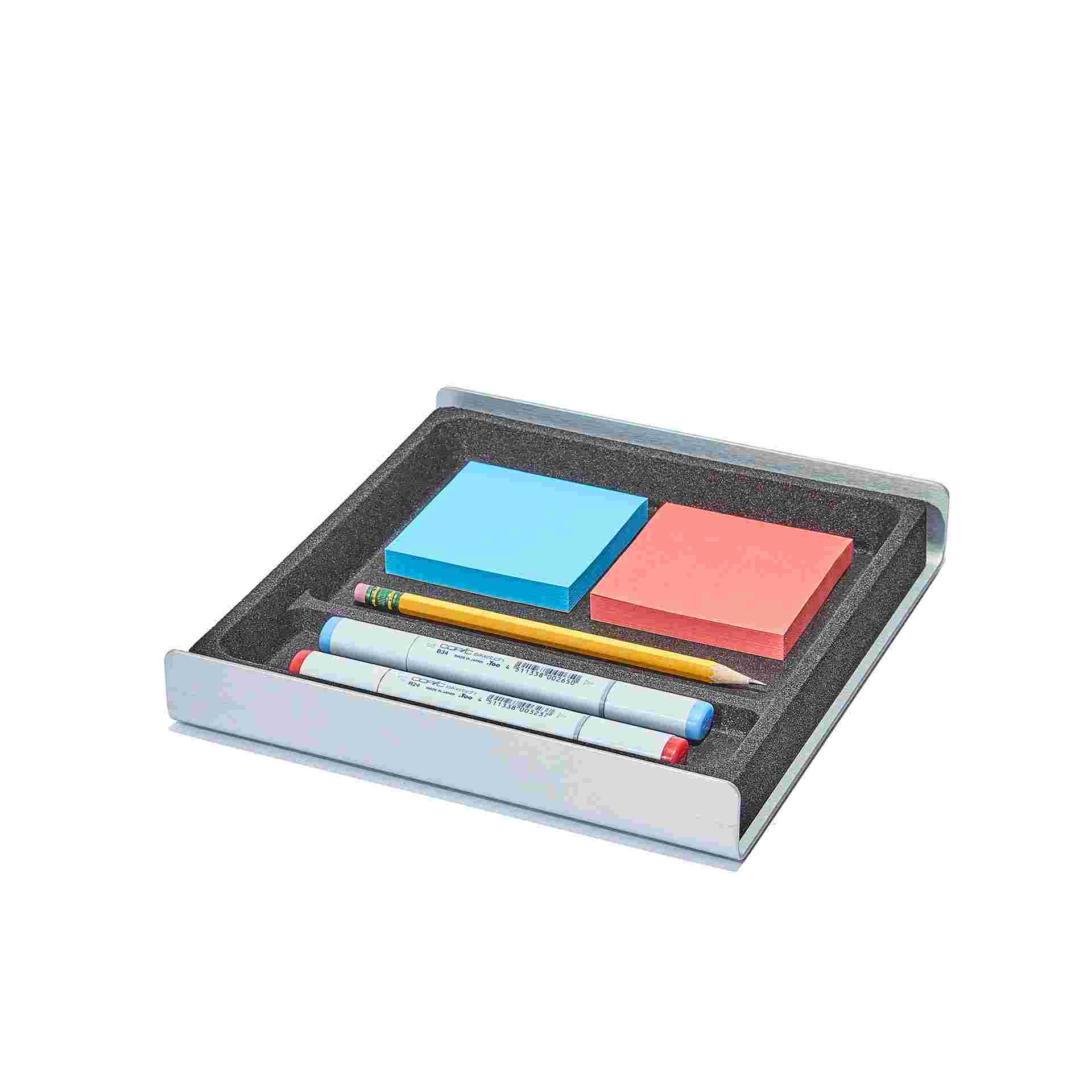 Medium black cork desk tray holding tools and sticky notes.