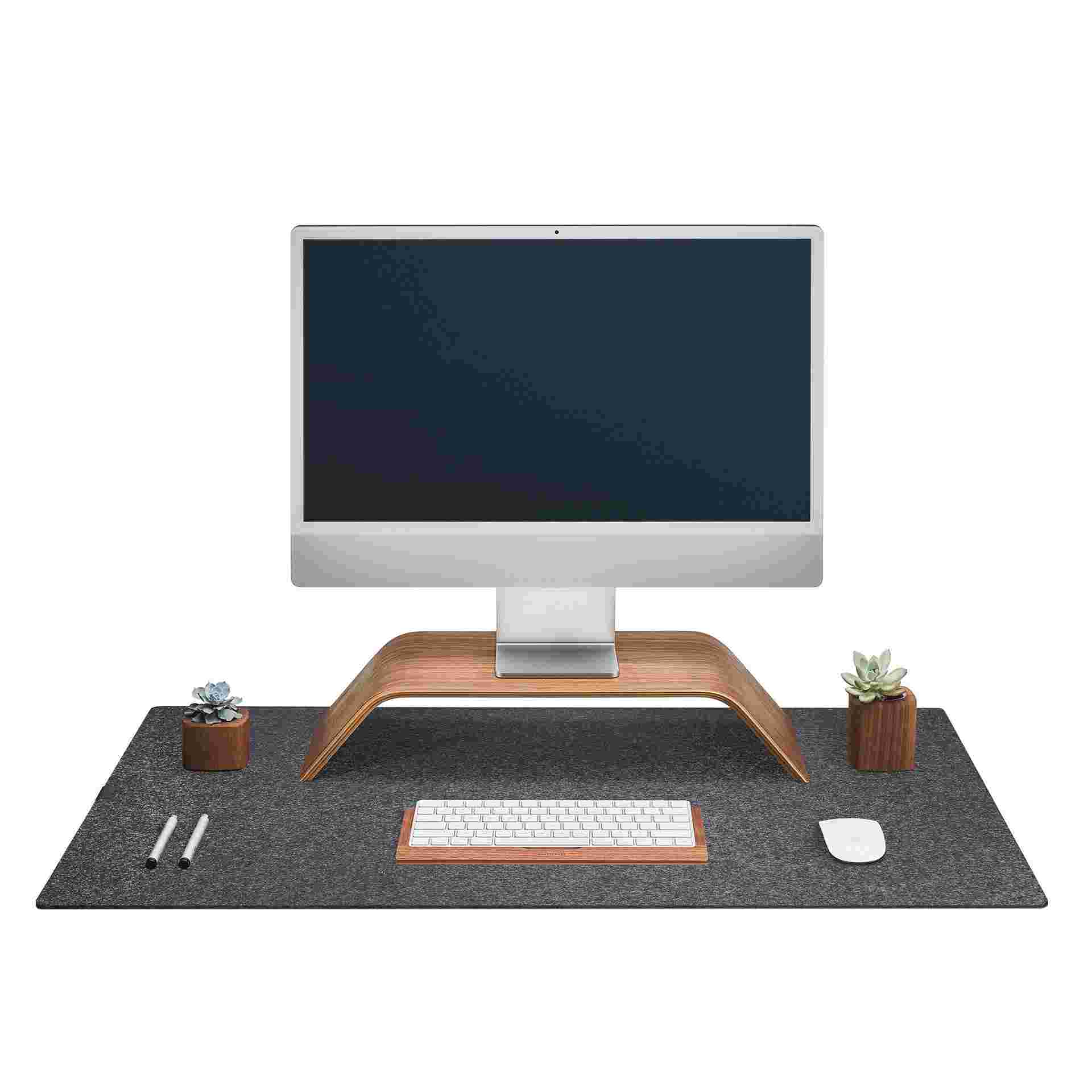 The Large Wool Felt Desk Pad in dark grey with the Walnut Monitor Stand, Keyboard Tray, and Mouse Pad.