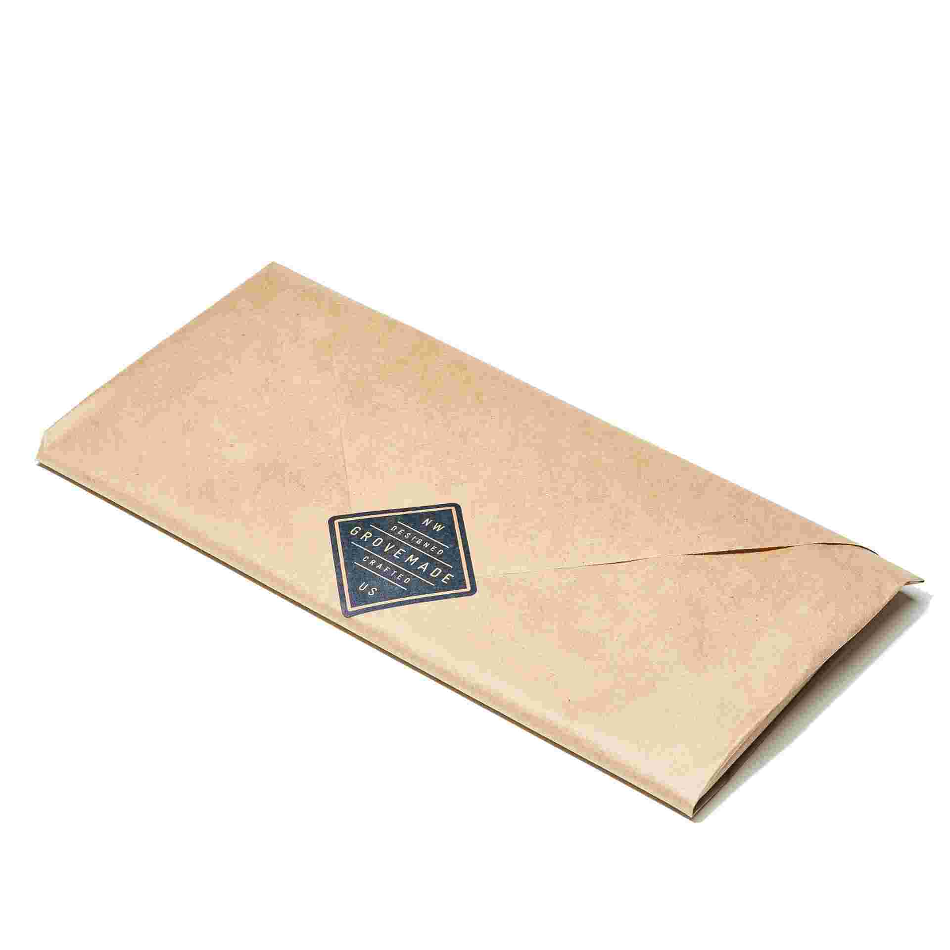 Walnut Keyboard Tray wrapped in brown craft paper.