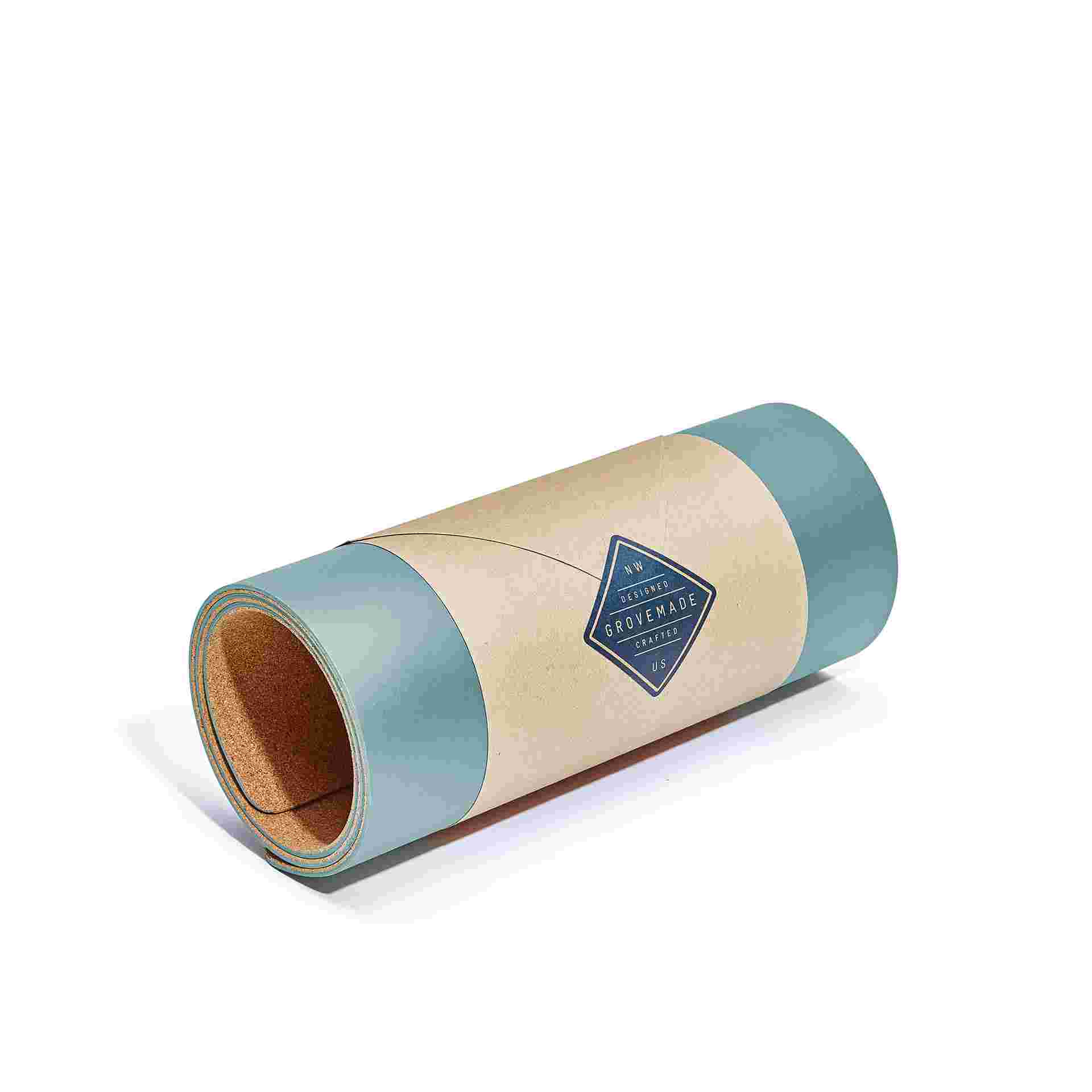 Small light blue desk pad, rolled in brown craft paper for easy gifting.
