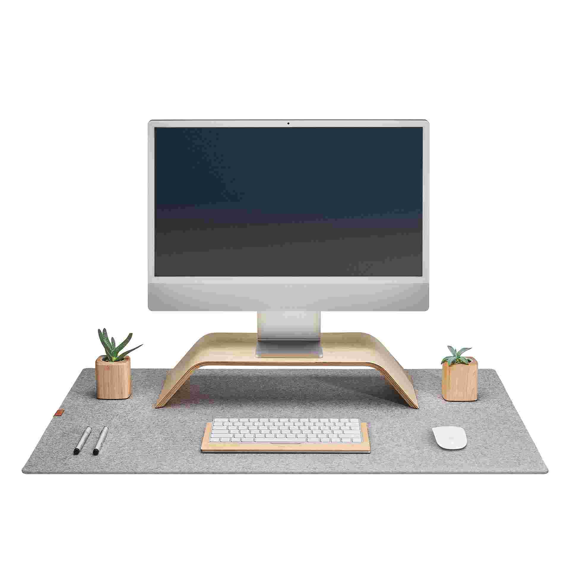 The Large Wool Felt Desk Pad in light grey with the Walnut Monitor Stand, Keyboard Tray, and Mouse Pad.