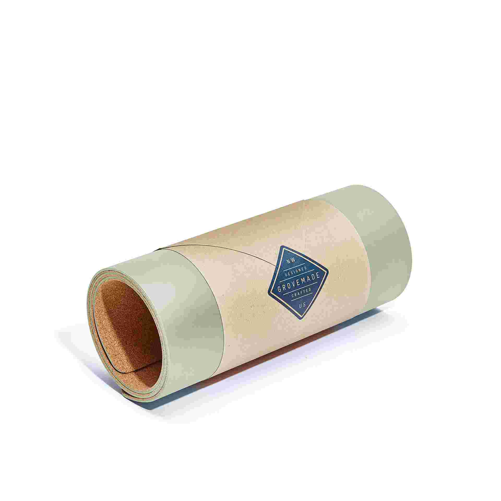 Small light green desk pad, rolled in brown craft paper for easy gifting.