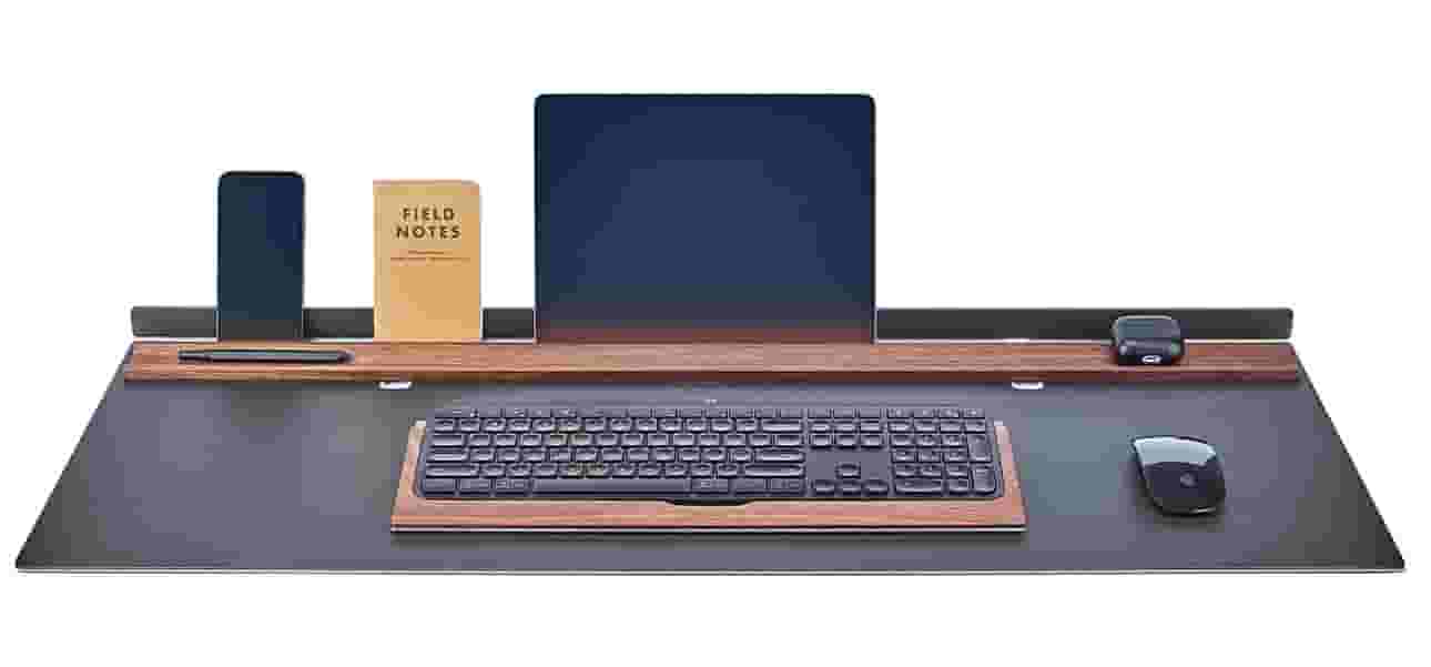 Matte black desk pad with solid walnut display rail.