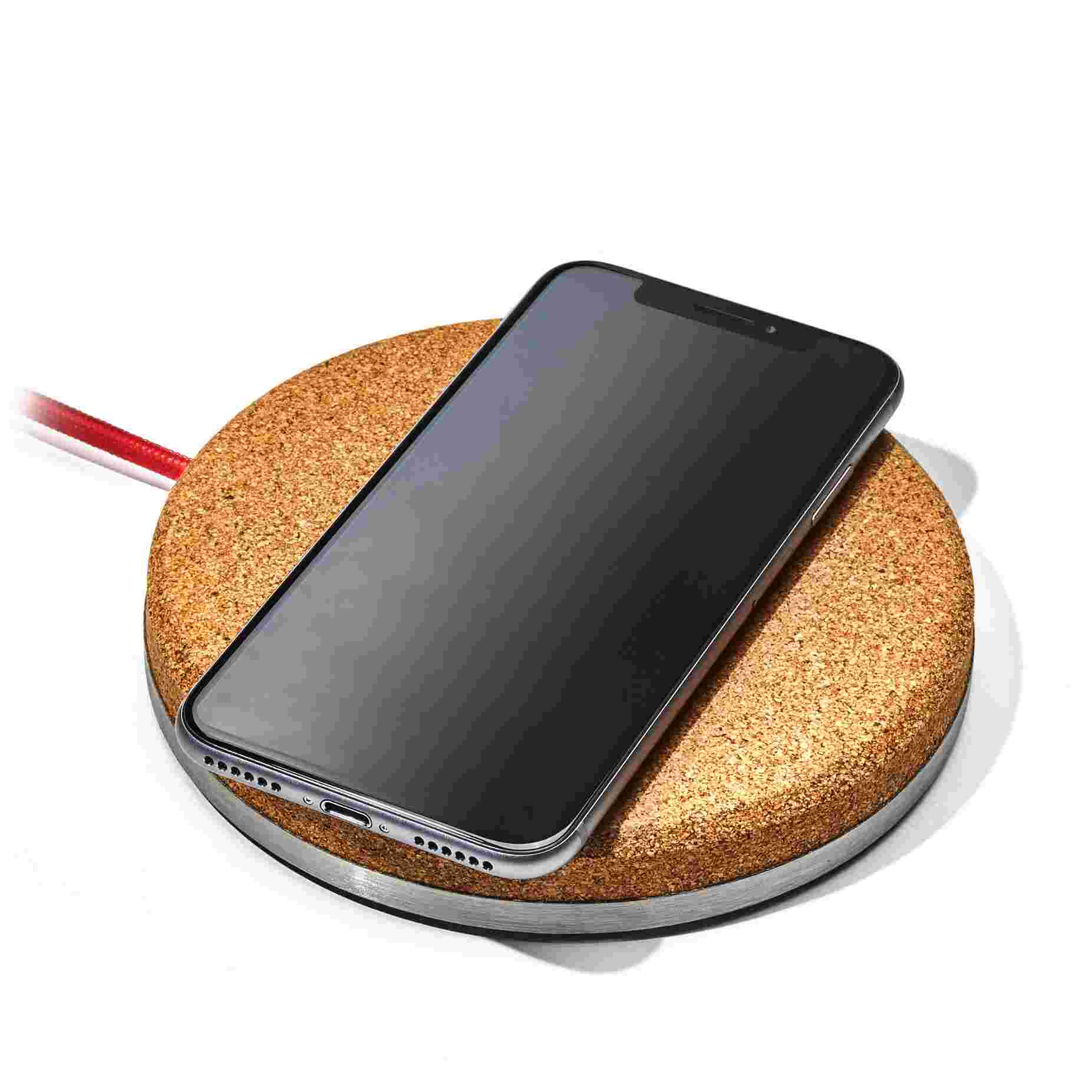 The Wireless Charging Pad in natural cork with an iPhone X.