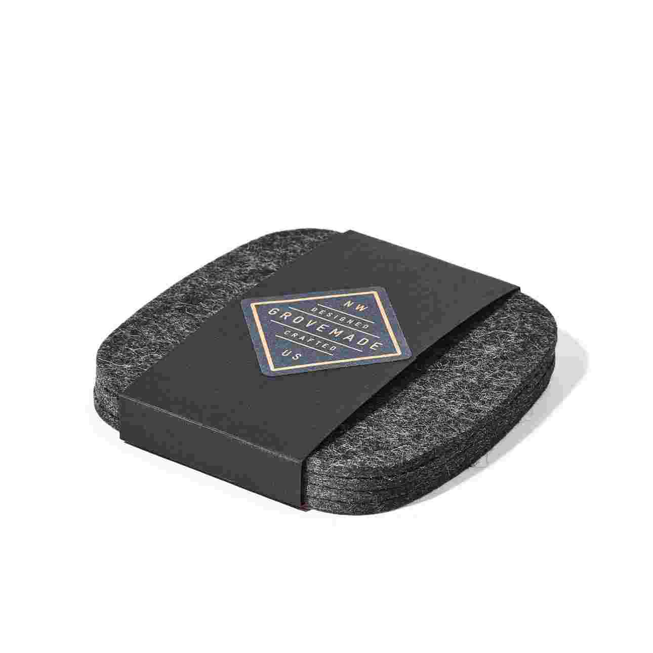 Dark felt coaster set in black paper packaging.