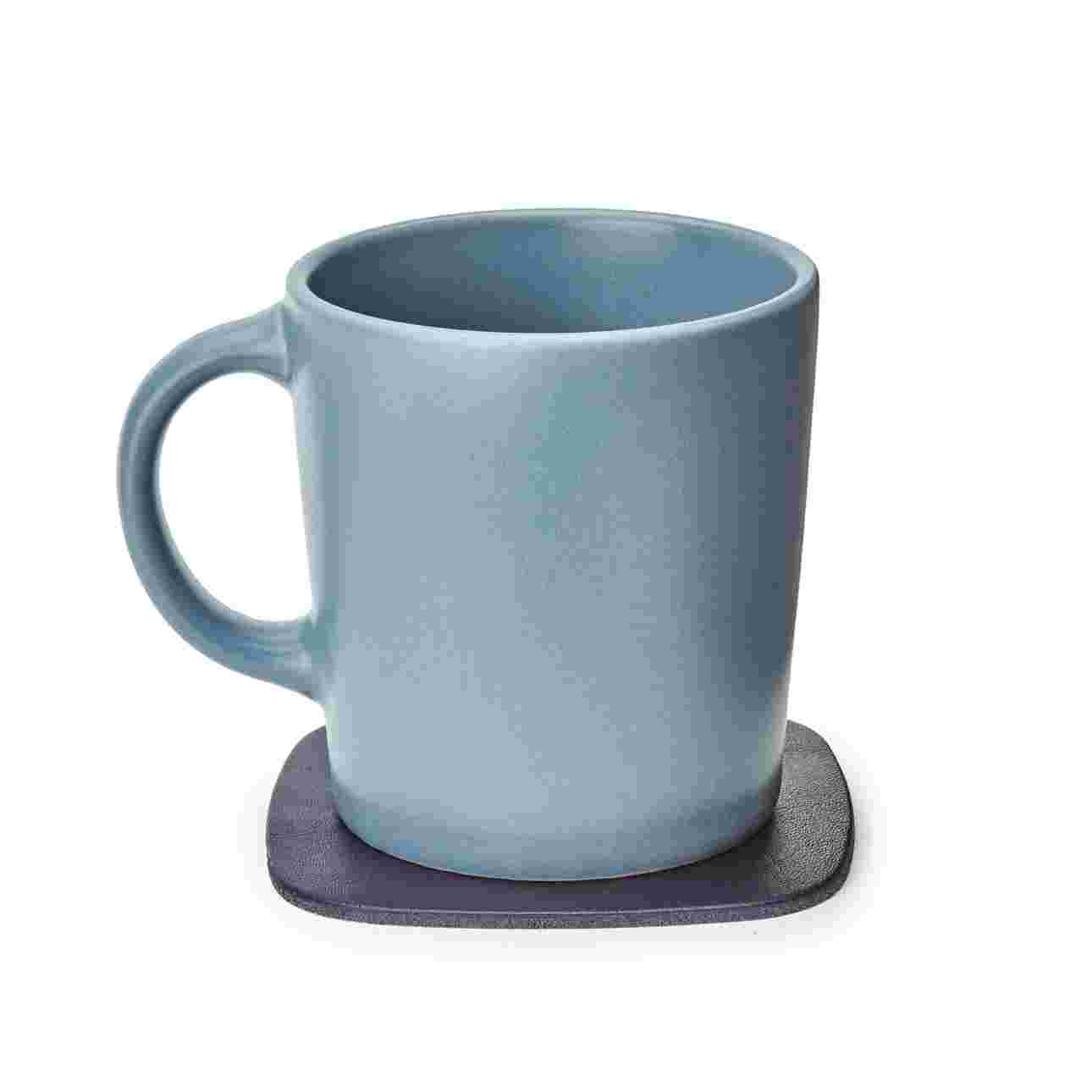 Black leather coaster with gray coffee cup.