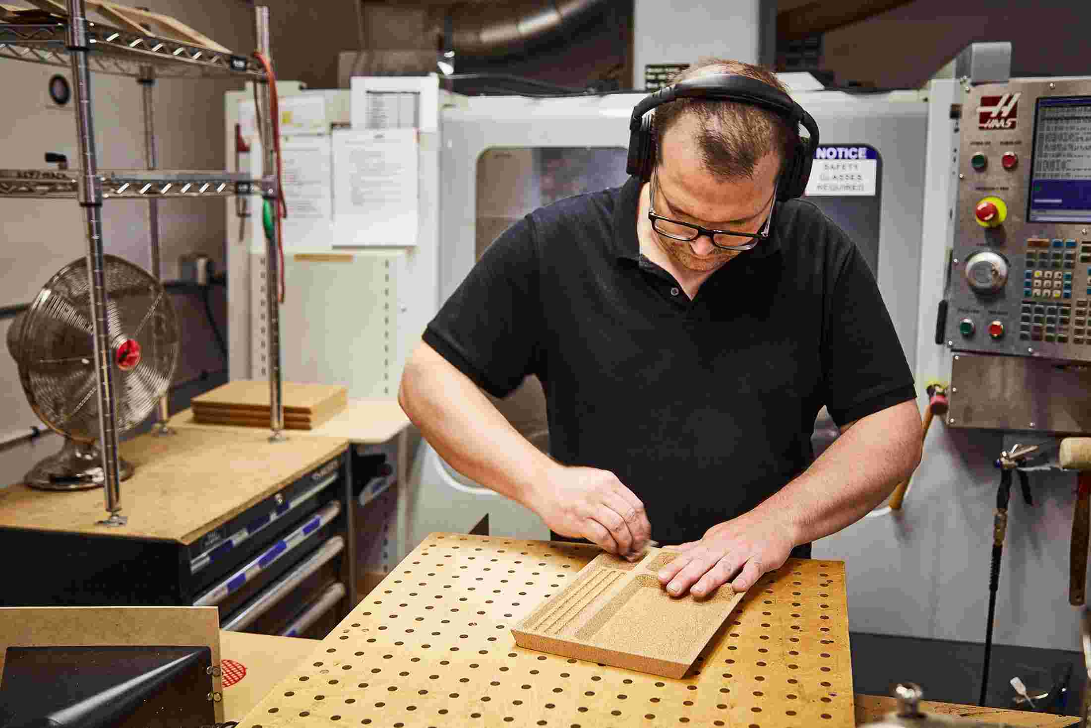 The Cork Desk Tray organizer being sanded by hand in Grovemade's Portland workshop.