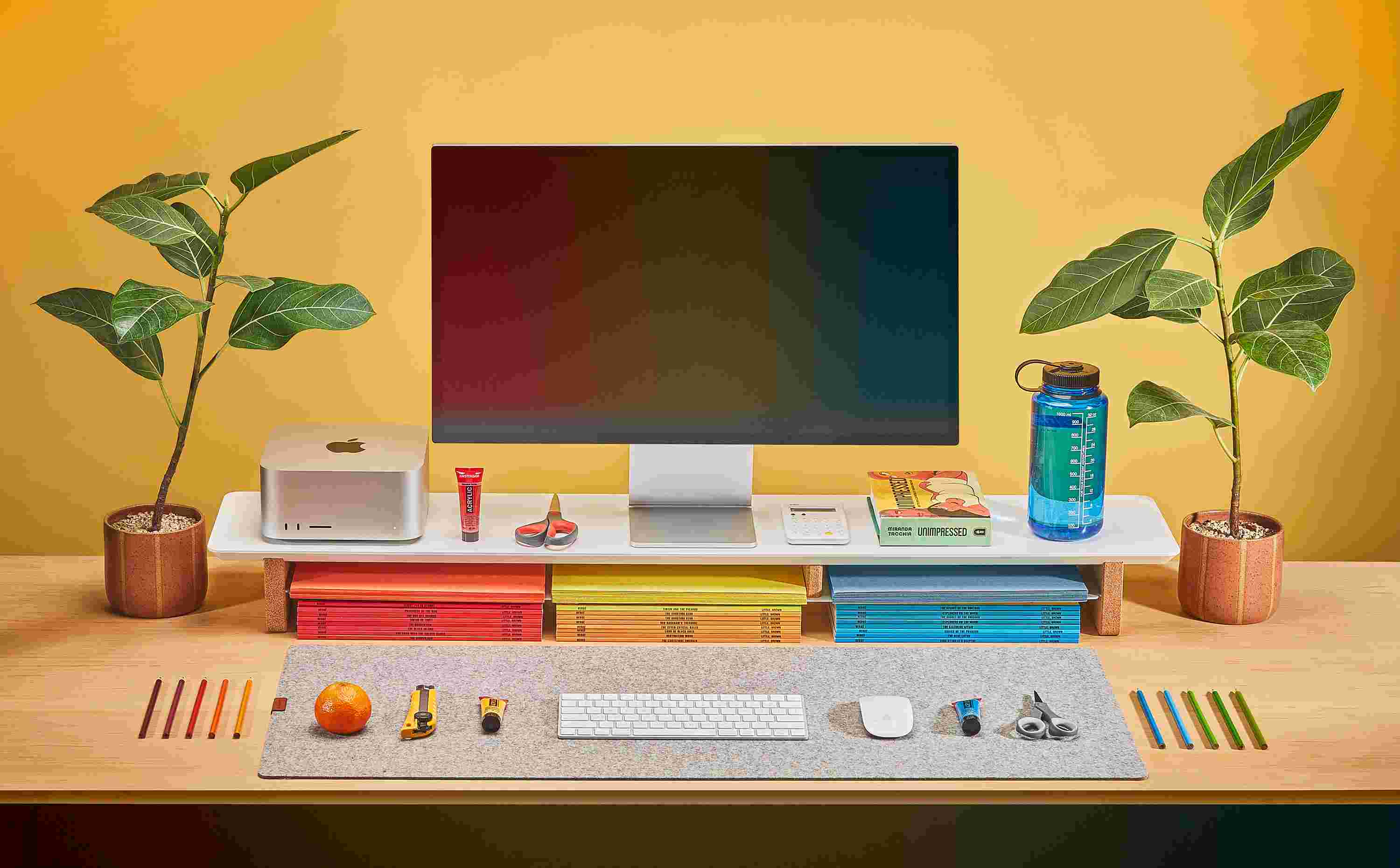 Matte White Desk Shelf on maple desktop with colorful books, paper, and crafting supplies.