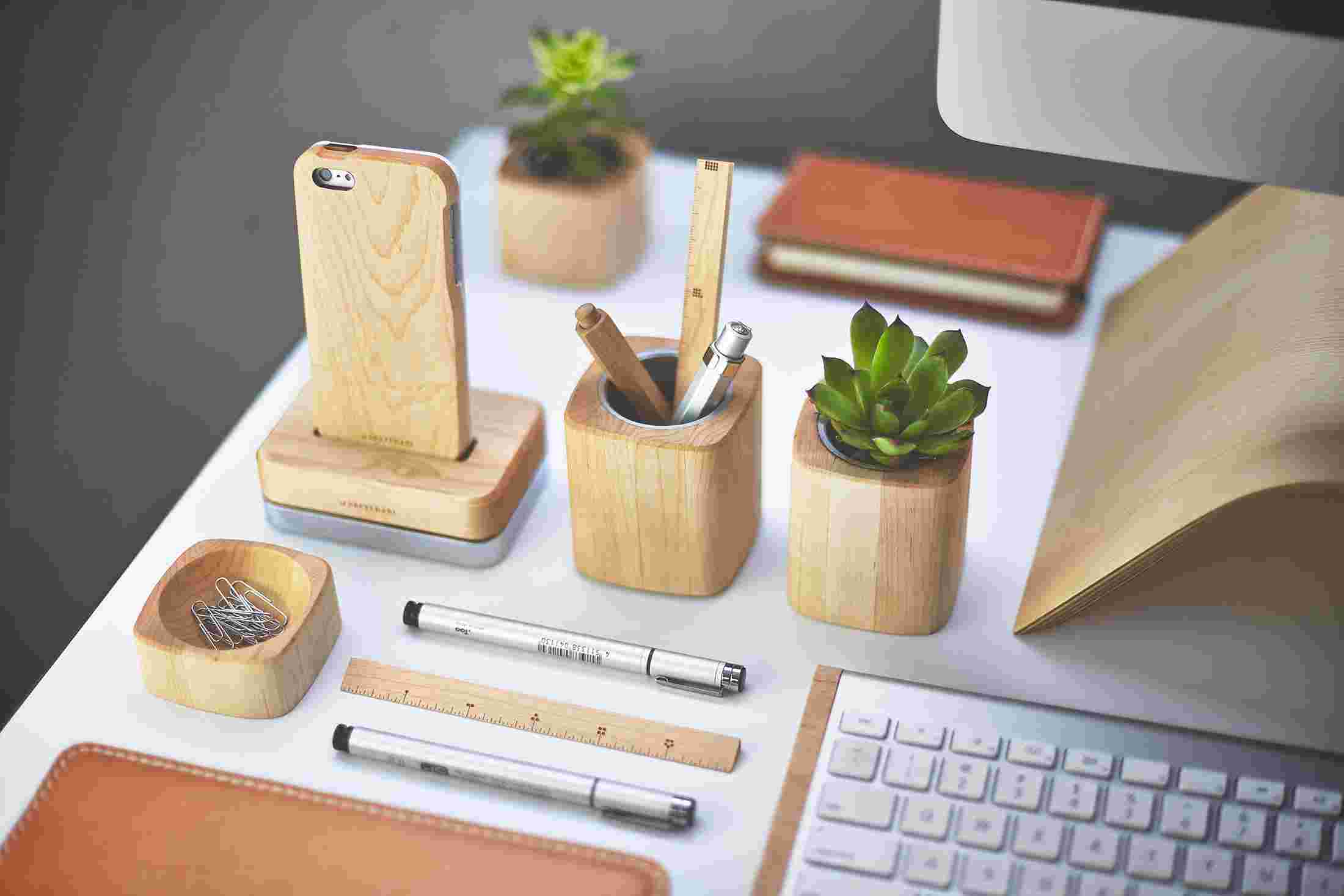 Array of original maple desk collection items—iPhone dock, minimalist wooden ruler, succulent planter, and tool pot.