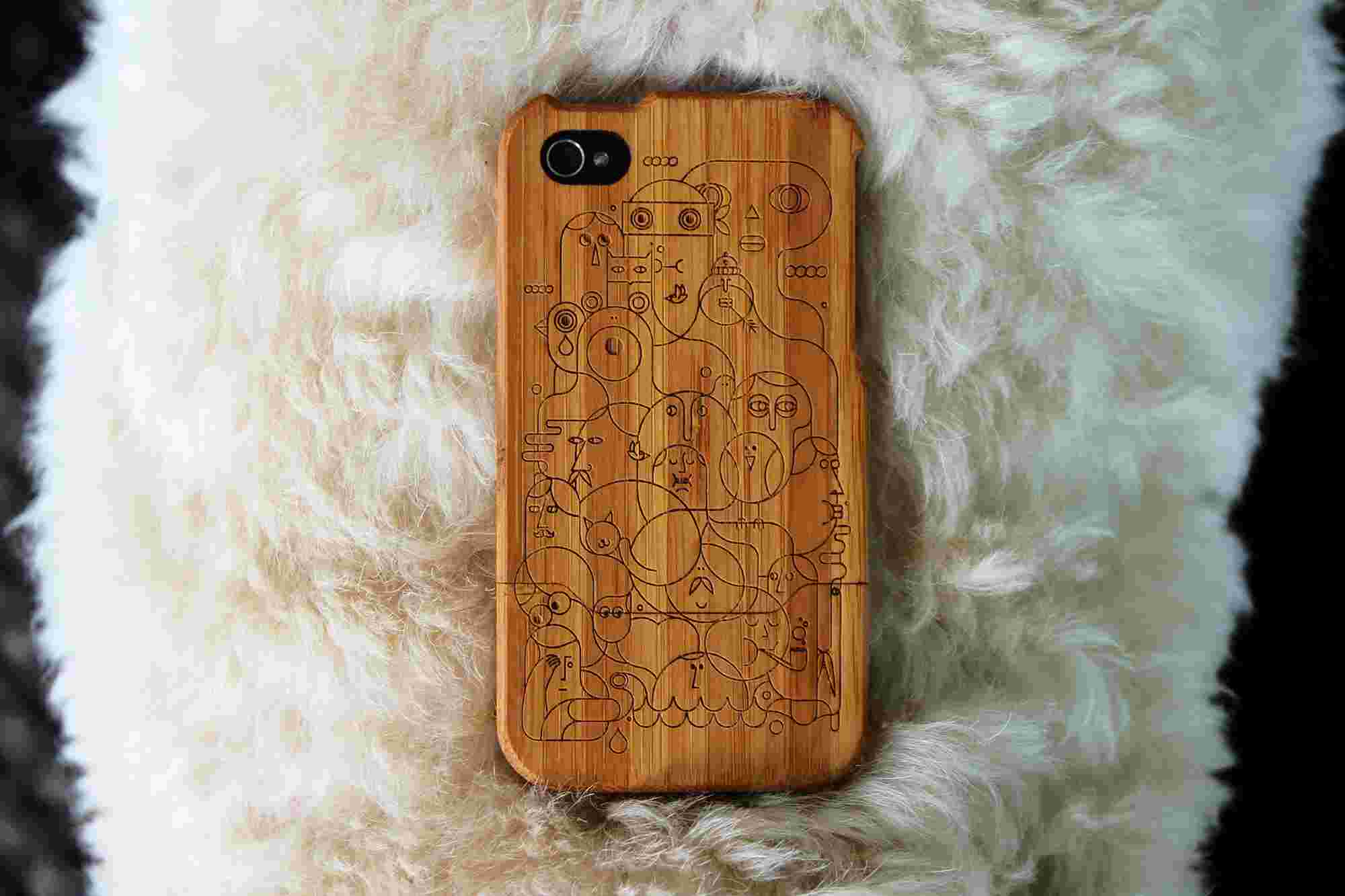 Bamboo iPhone Case photographed on the back of a fluffy labradoodle, featuring the artwork "Family" by Happy Lovers Town.