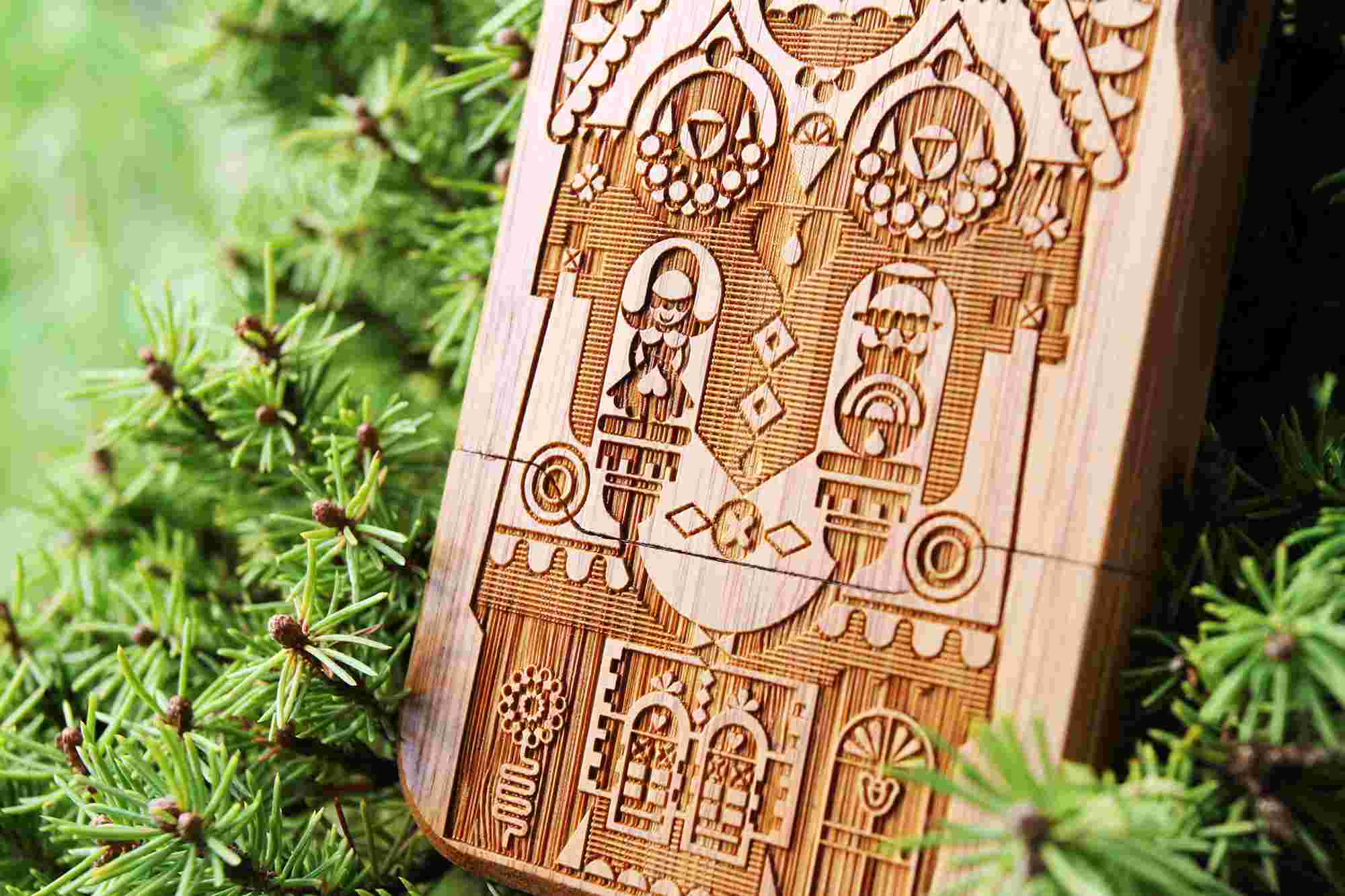Close up of illustration "Weather Station" by c86, engraved on bamboo iPhone case perched in a tree.