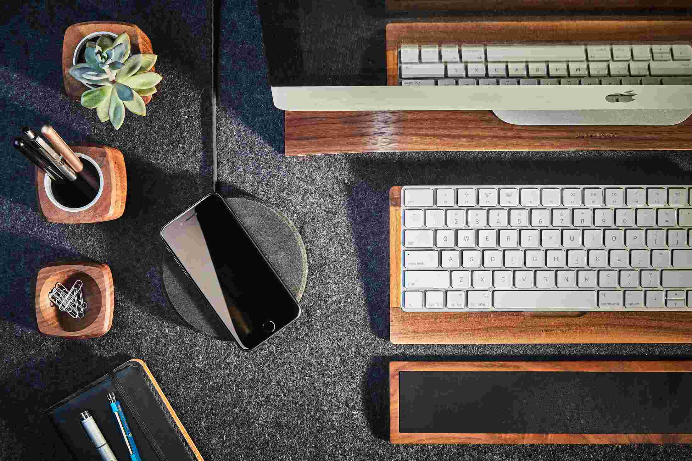 Overhead view of the Grovemade Wireless Charging Pad with dark cork top as part of the Walnut Desk Collection.