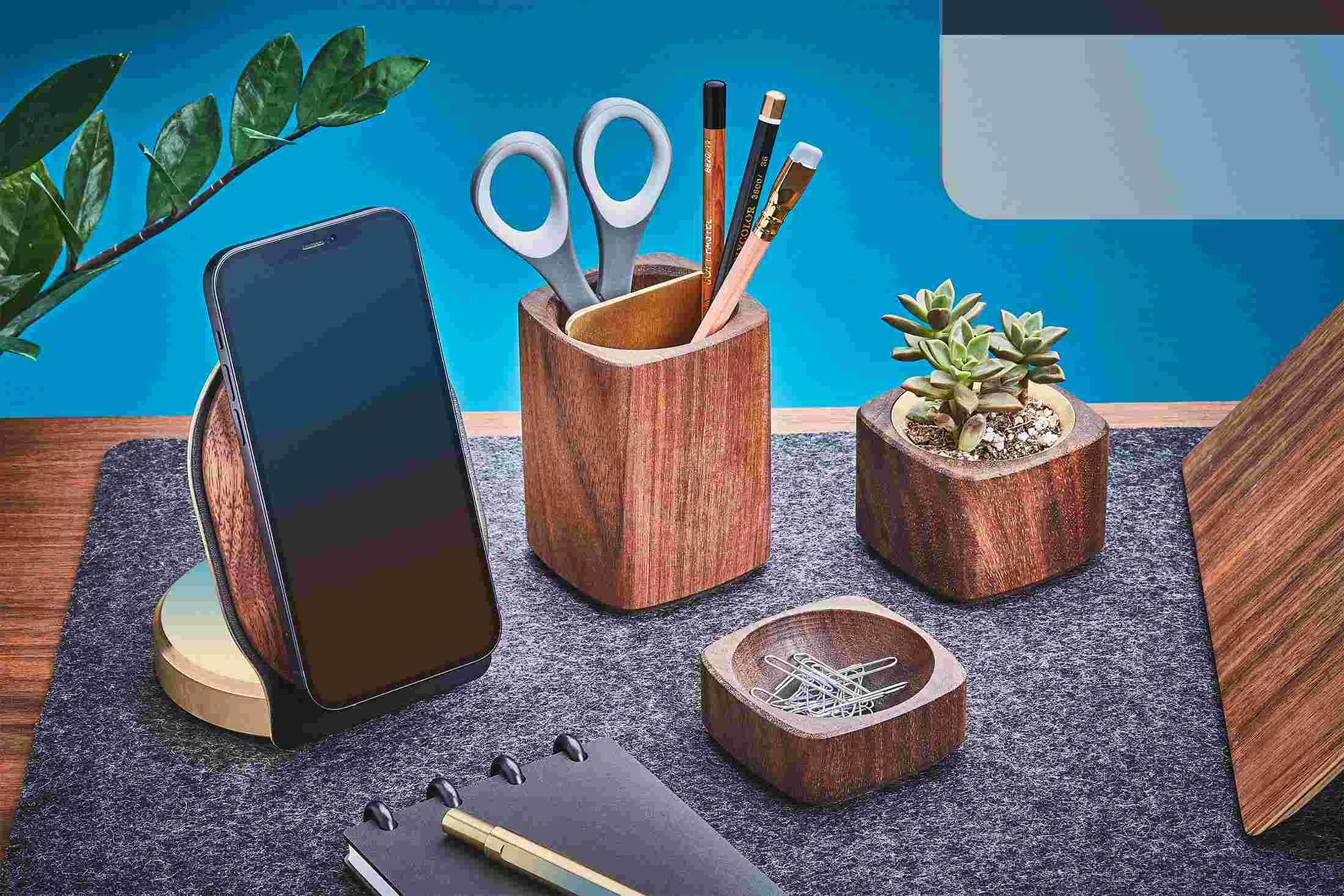 Brass and wood iPhone 12 MagSafe Holder on wool felt desk pad with matching desk accessories.