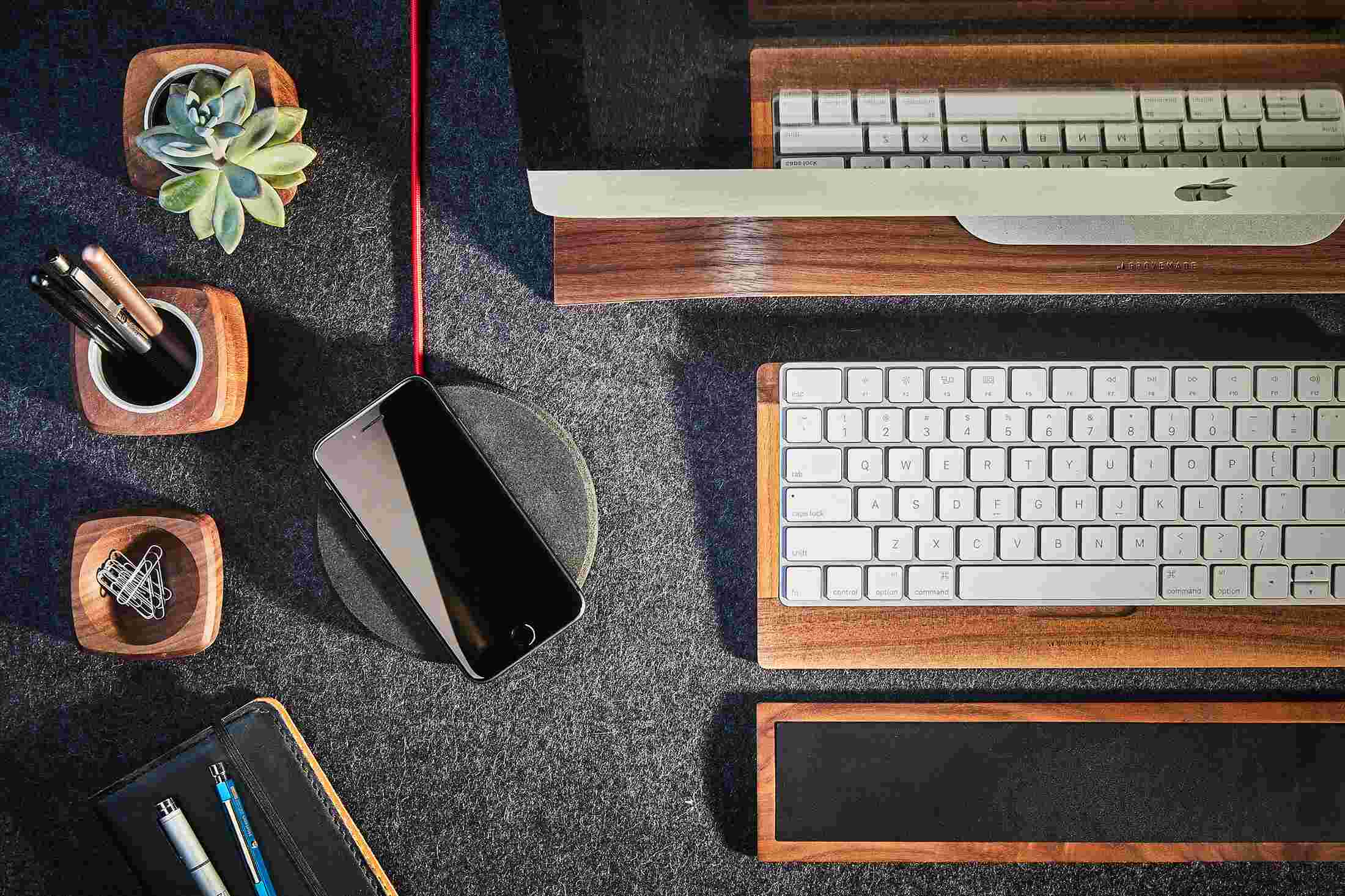 Overhead view of the Grovemade Wireless Charging Pad with dark cork top as part of the Walnut Desk Collection.