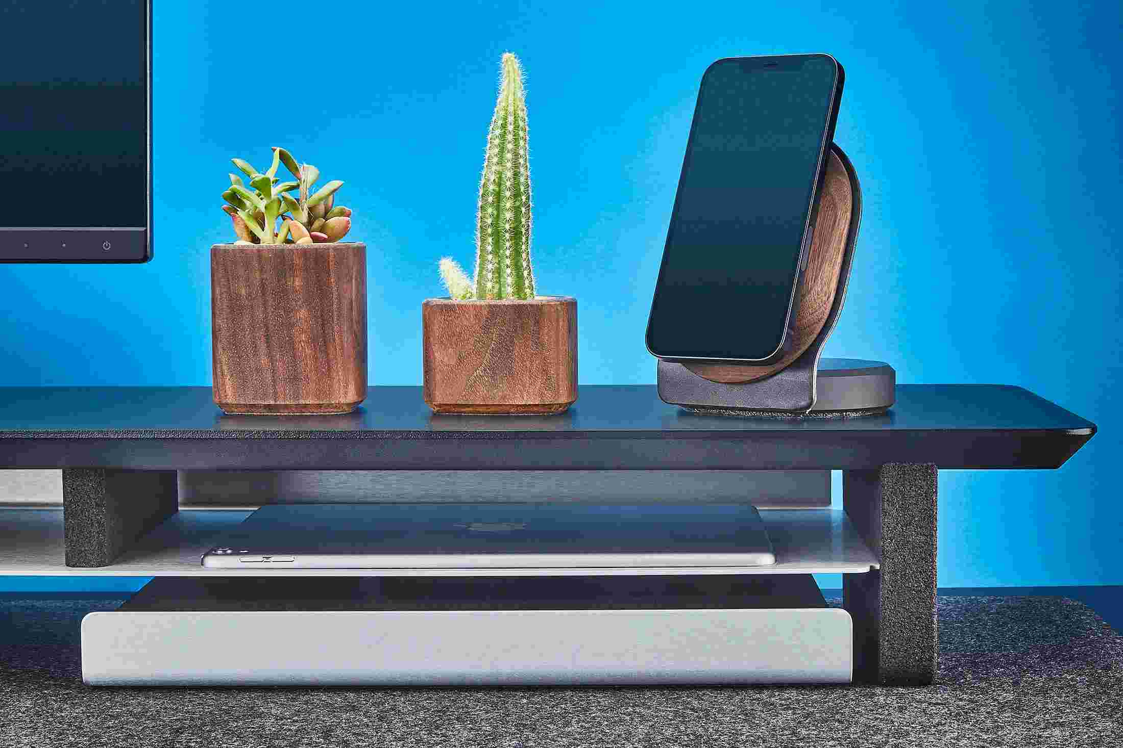 The desk shelf's integrated storage shelf holding both a 12.9 inch iPad Pro and 9.7 inch iPad.