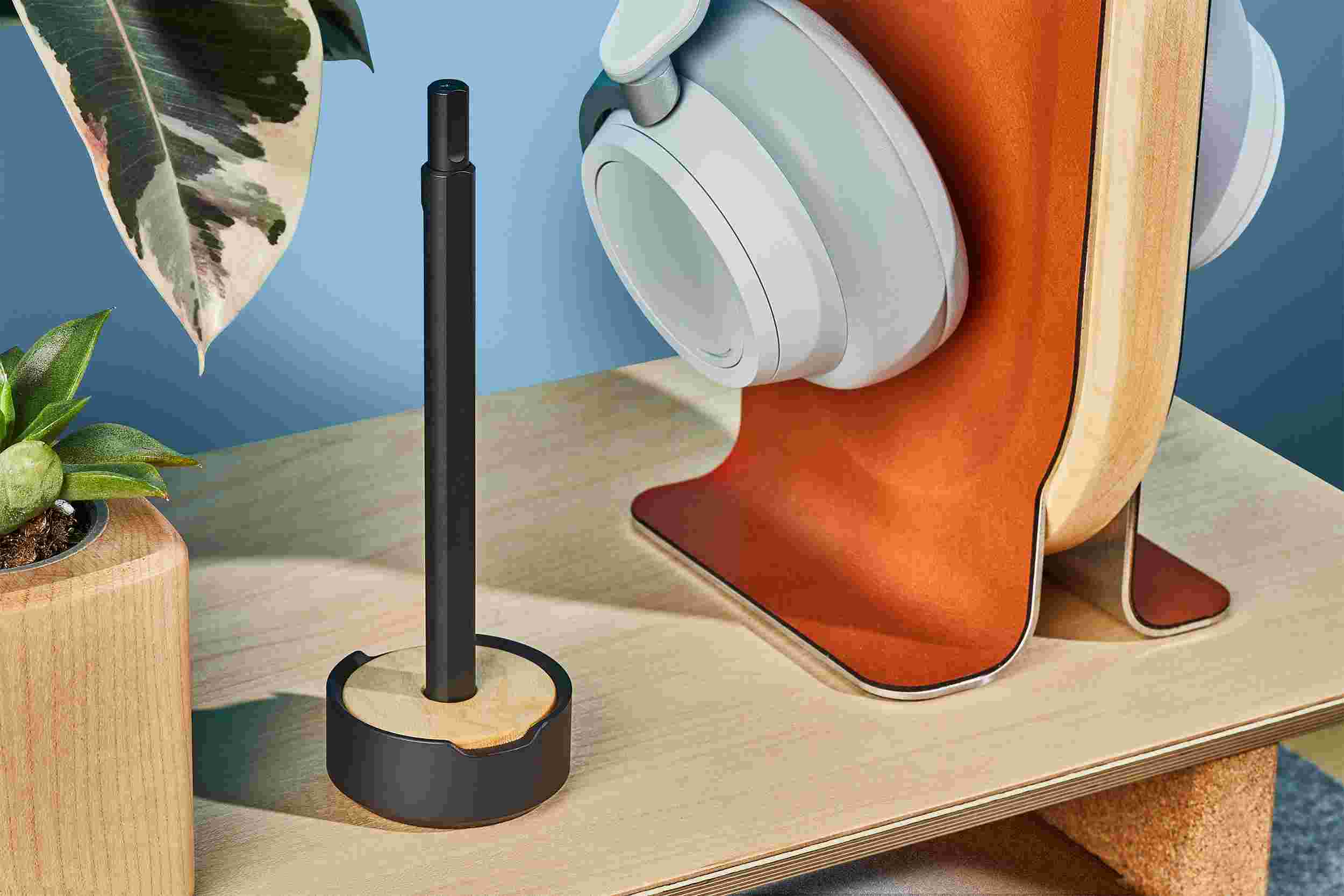 The Grovemade Black Pen and Maple Pen Stand, on a lighter, maple desktop.