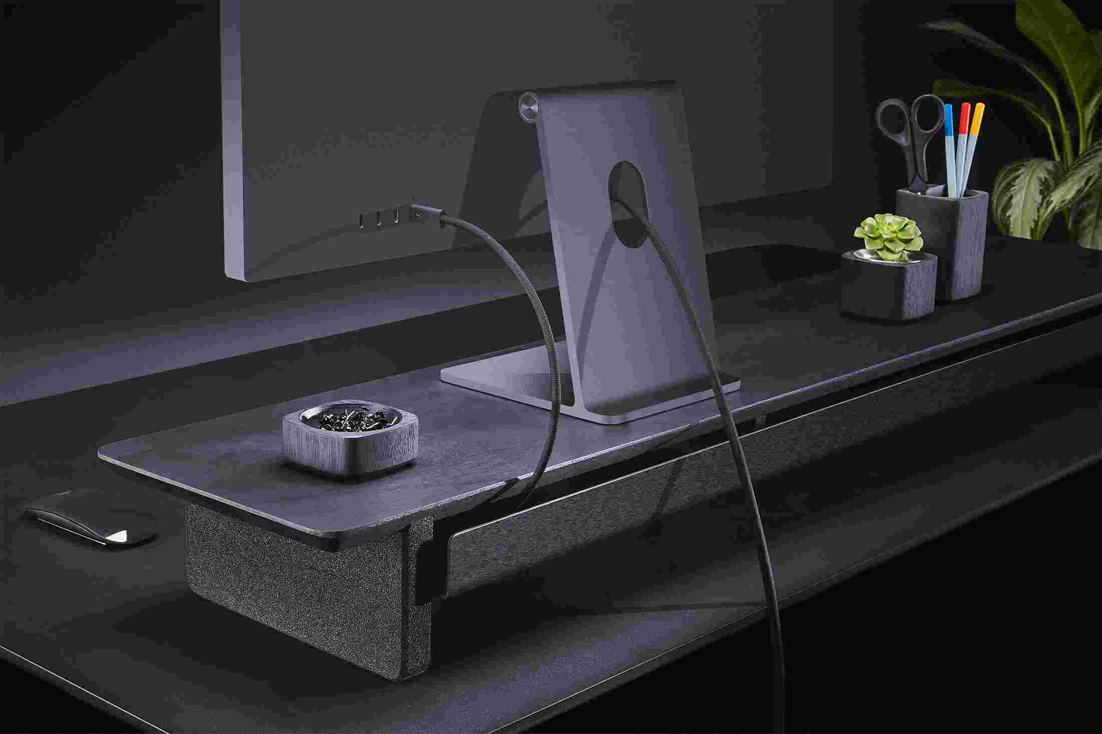 Rear view of the blackened walnut shelf showing the back edge of the bent metal shelf, designed to keep your stuff in place, while leaving space for hidden cord access.