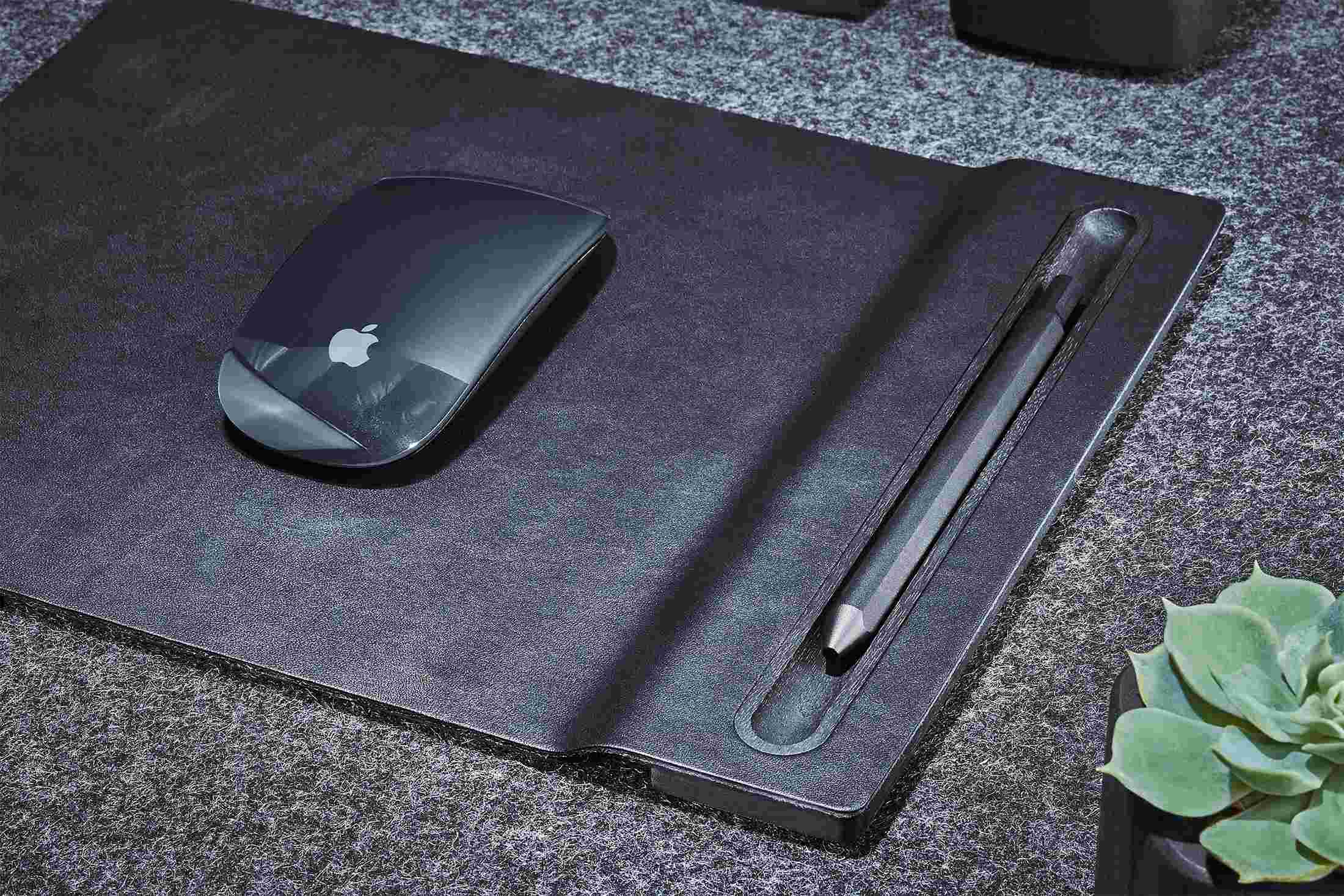 Detail of the blackened walnut and leather mouse pad with sculpted pen tray.
