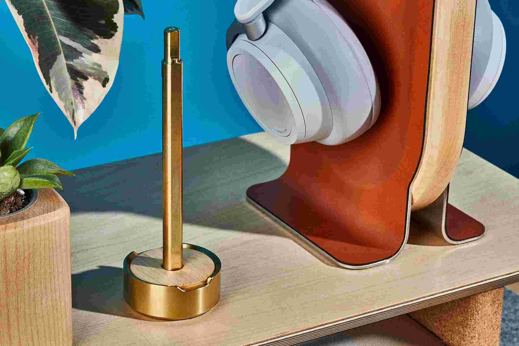 The Grovemade Brass Pen and Maple Pen Stand, on a lighter, maple desktop.