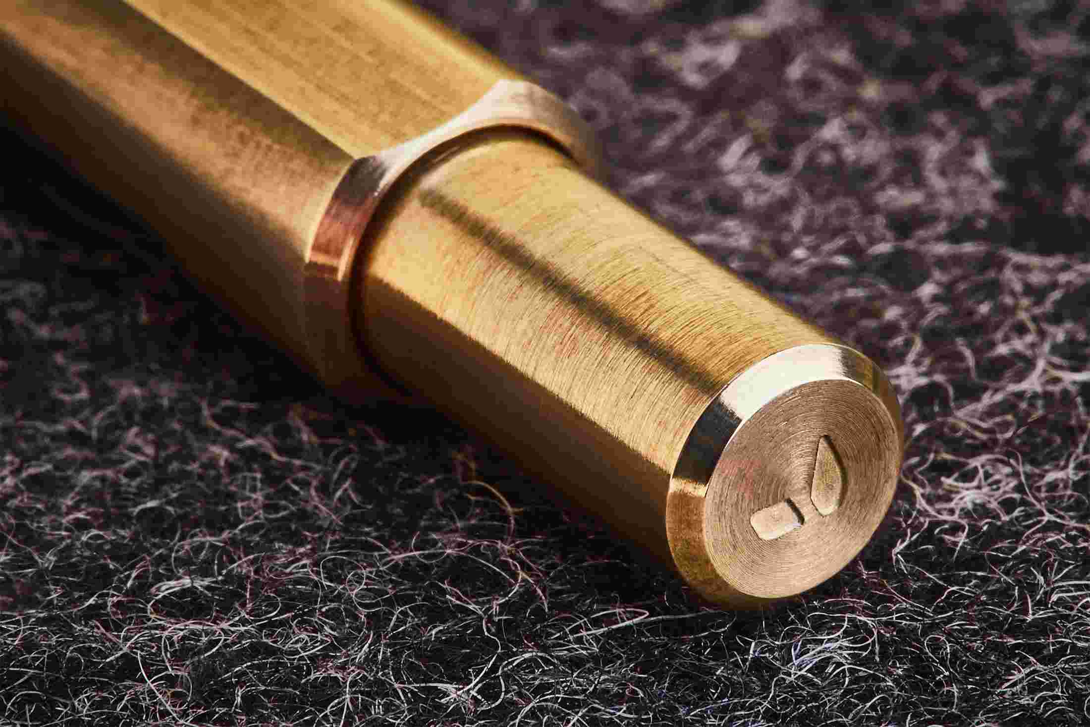 Close up detail of the twist on the top of the brass pen.