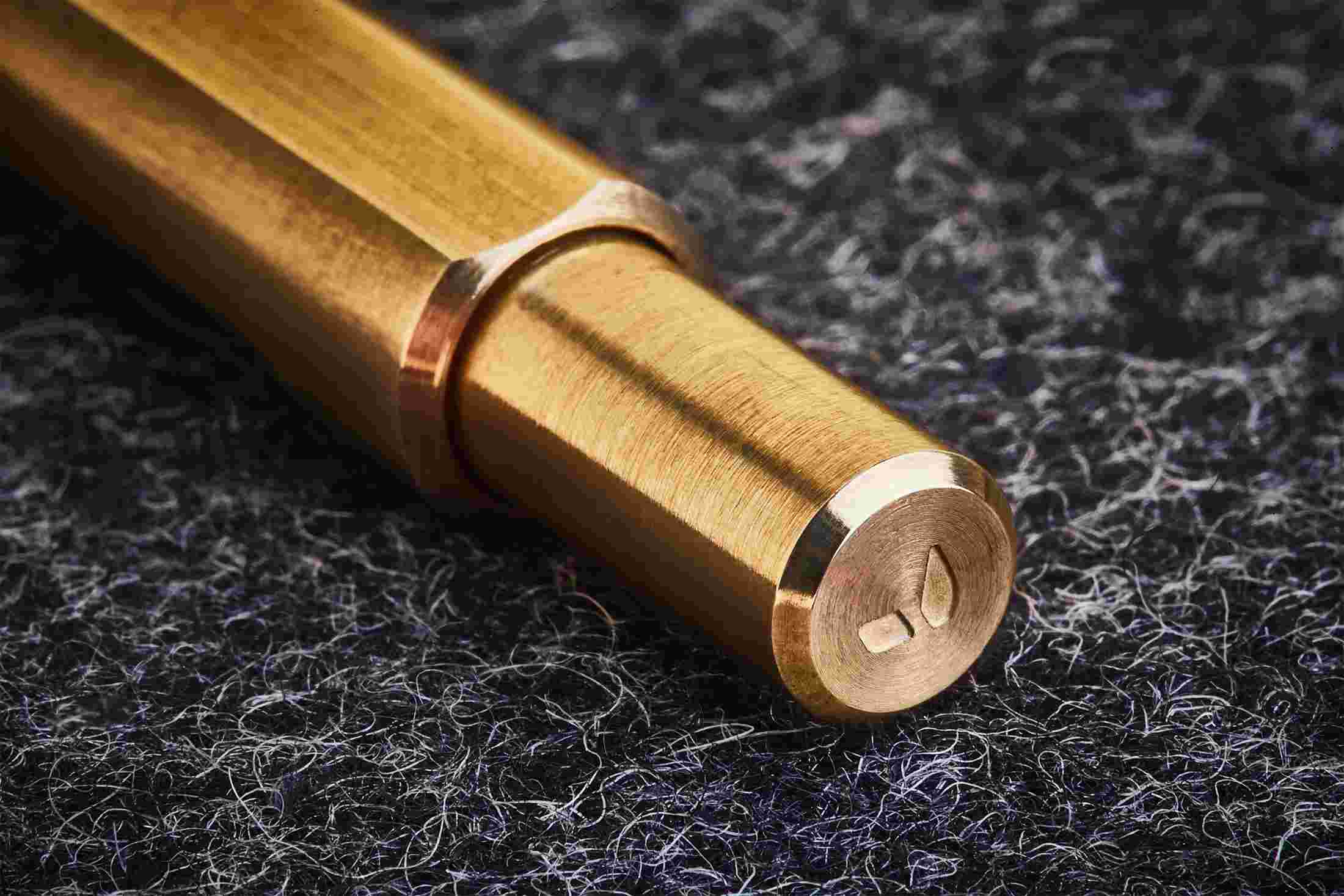 Close up detail of the twist on the top of the brass pen.