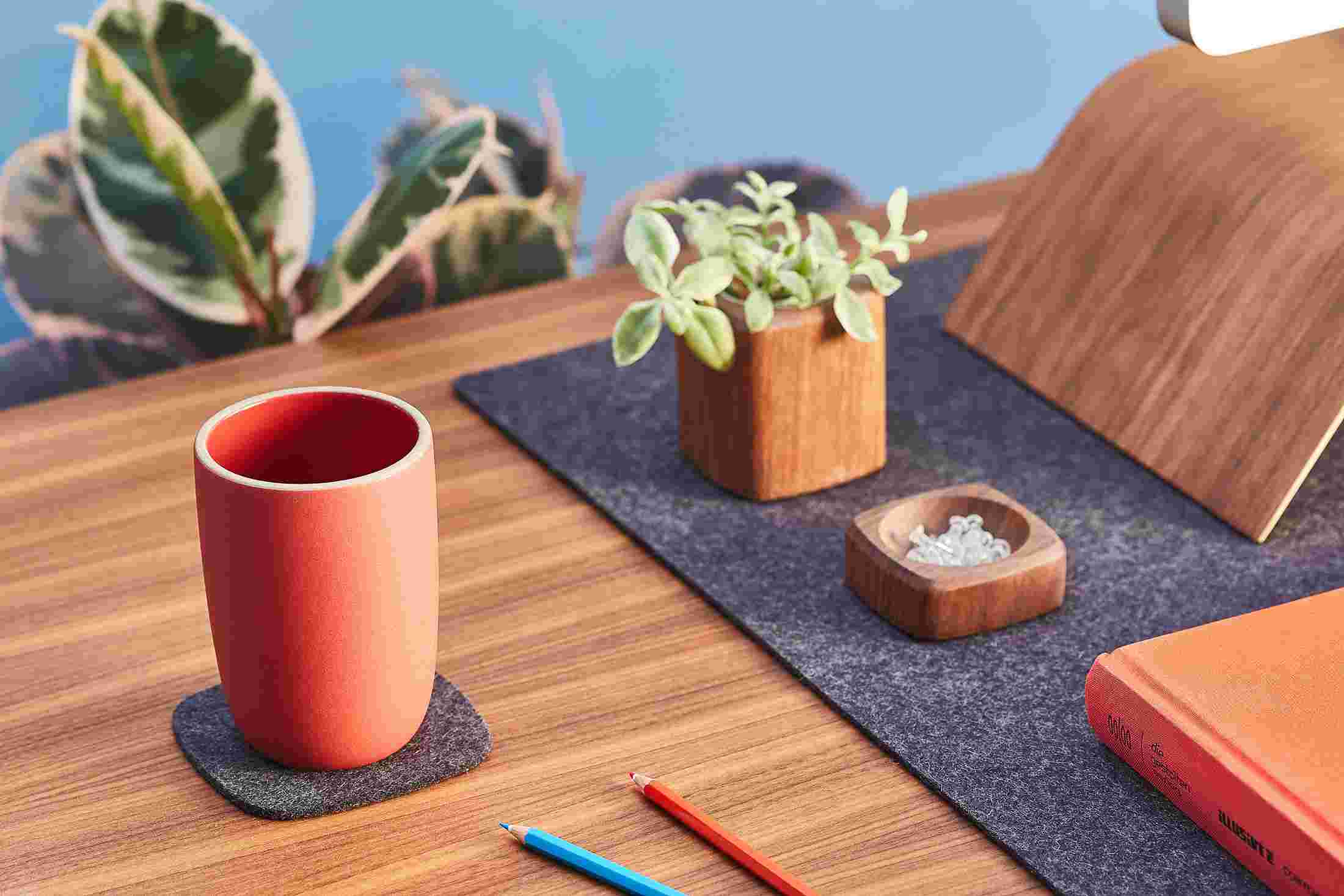 The dark wool felt coaster matching the Grovemade Wool Felt Desk Pad.