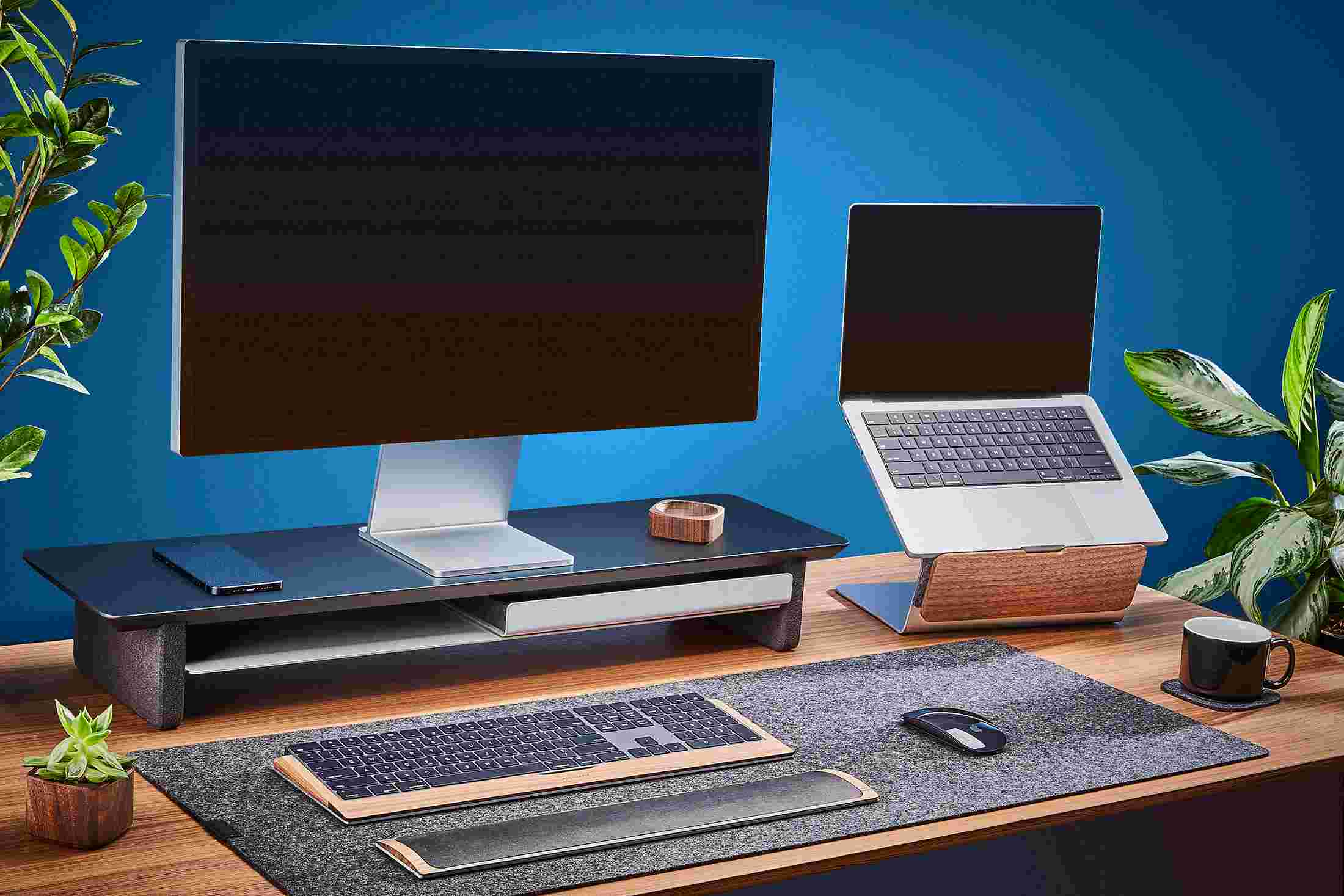 The medium Matte Black Desk Shelf and Laptop Riser, paired with medium dark grey wool felt desk pad.