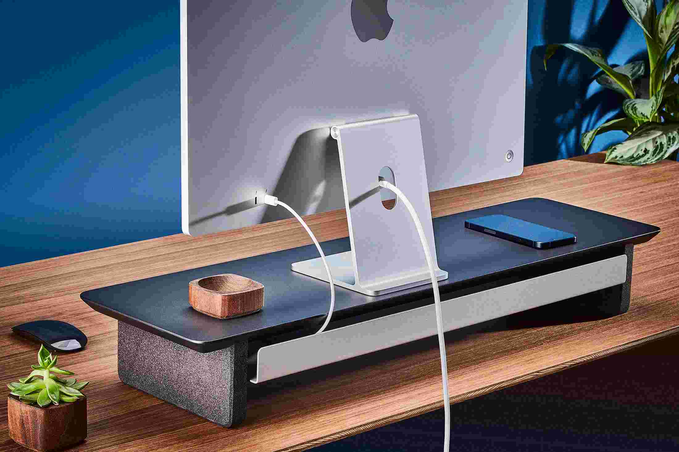 Rear view of the medium matte black monitor organizer showing the back edge of the bent metal shelf, designed to keep your stuff in place, while leaving space for hidden cord access.