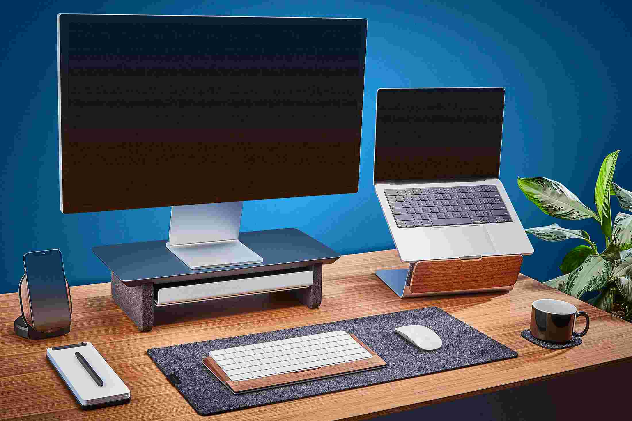 The small Matte Black Desk Shelf and Laptop Riser for small desktops, paired with small wool felt desk pad.