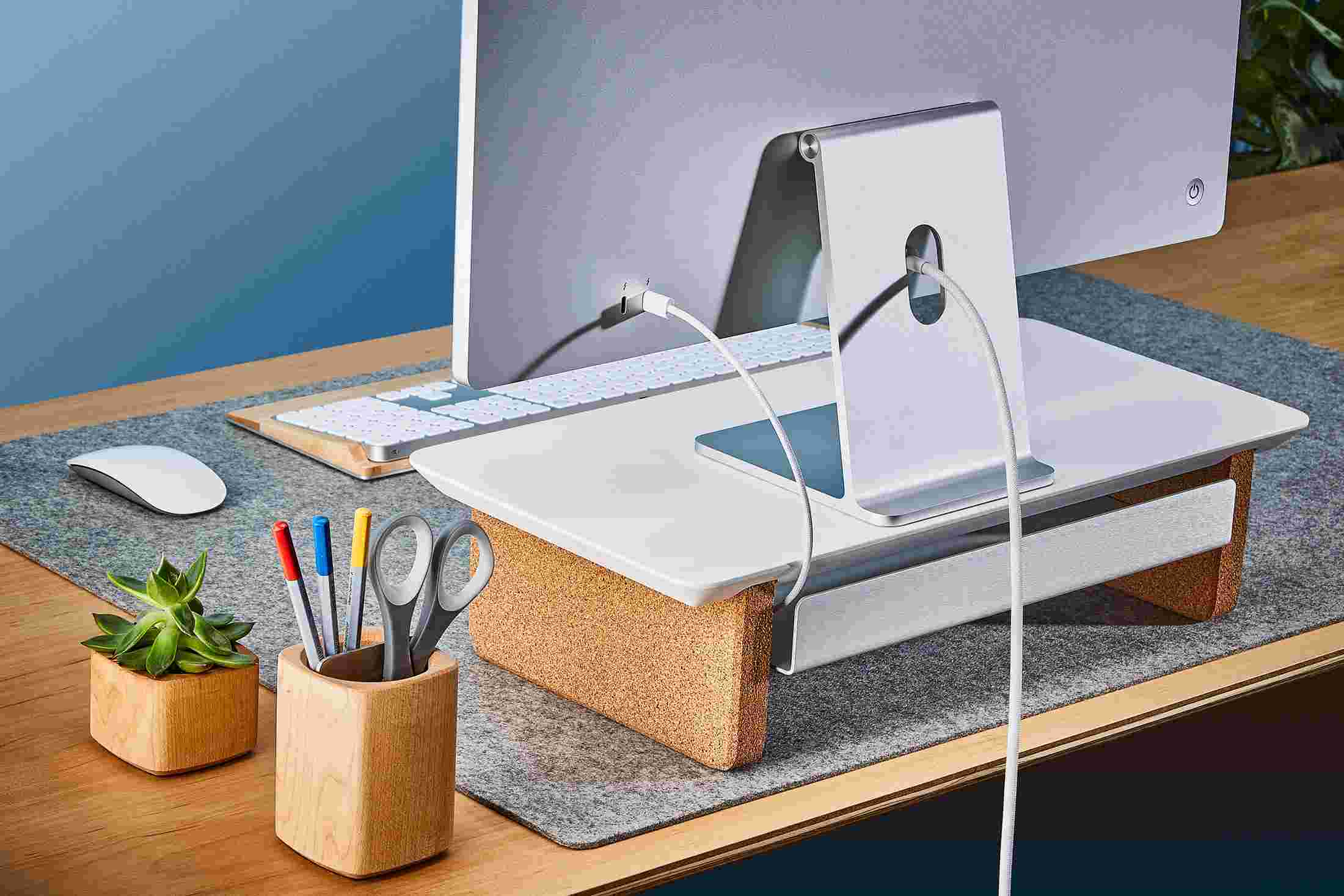 Rear view of the small white black monitor organizer showing the back edge of the bent metal shelf, designed to keep your stuff in place, while leaving space for hidden cord access.