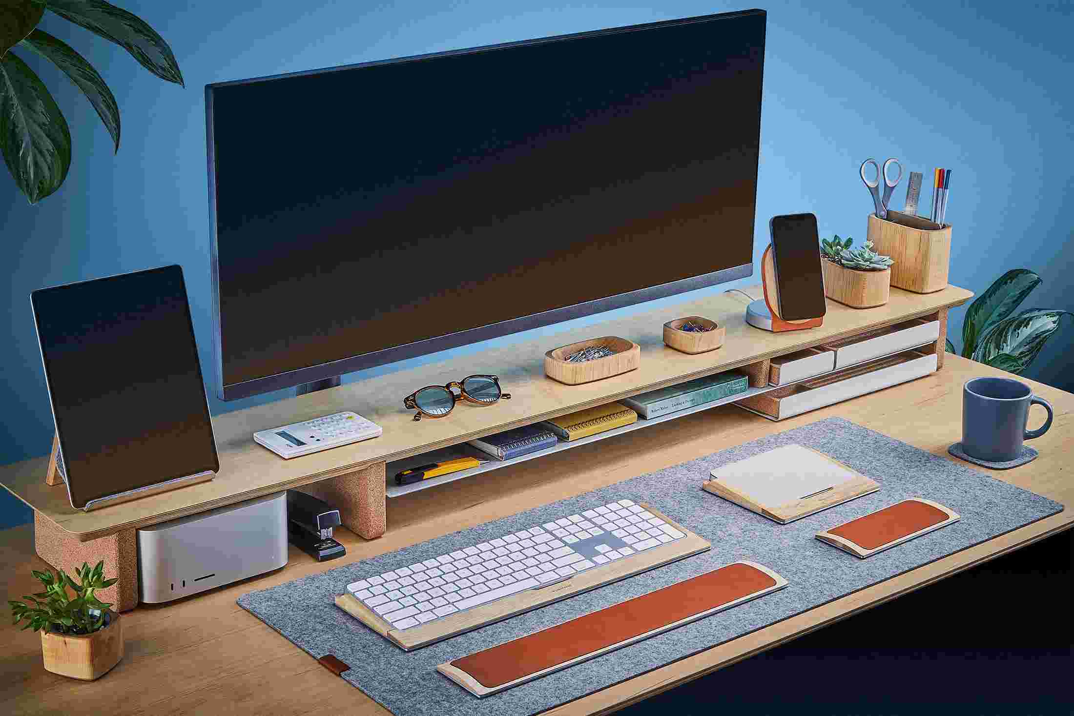 The Extra Large Felt Desk Pad covering almost an entire desktop, in use with the Maple Desk Shelf System.