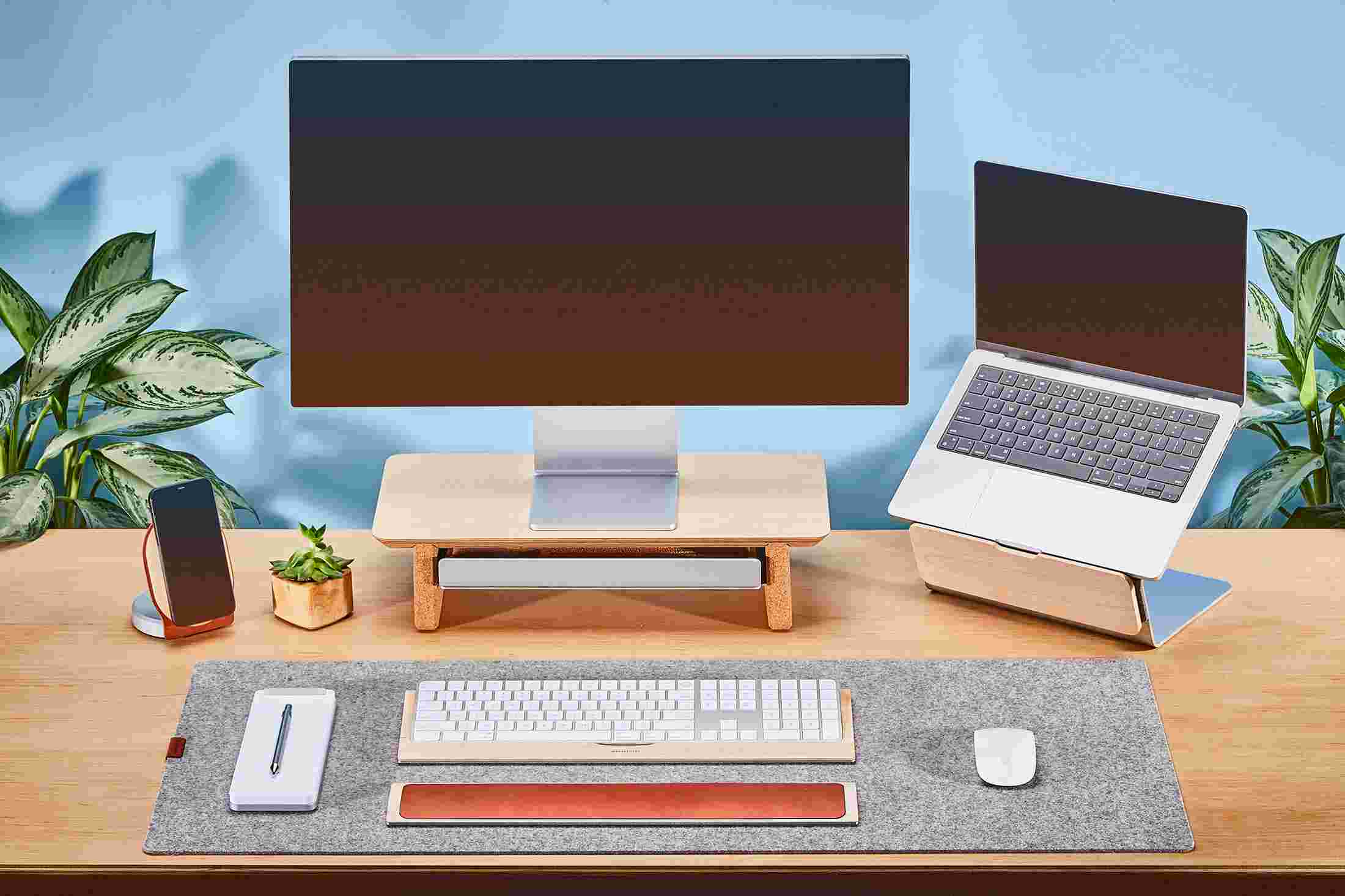 Small Maple Monitor Stand with Apple Studio Display and matching walnut laptop stand for MacBook.