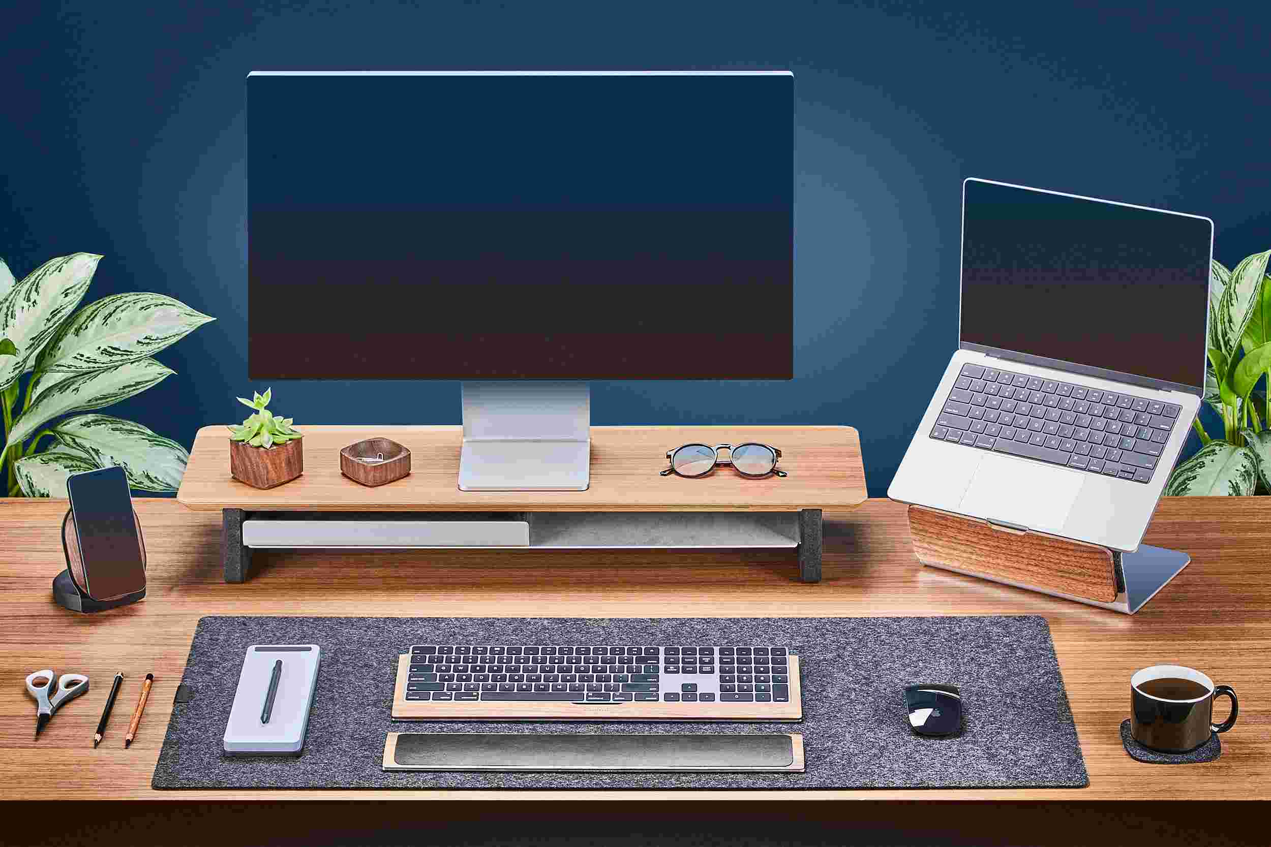 Medium Walnut Monitor Stand with Apple Studio Display and matching walnut laptop stand for MacBook.