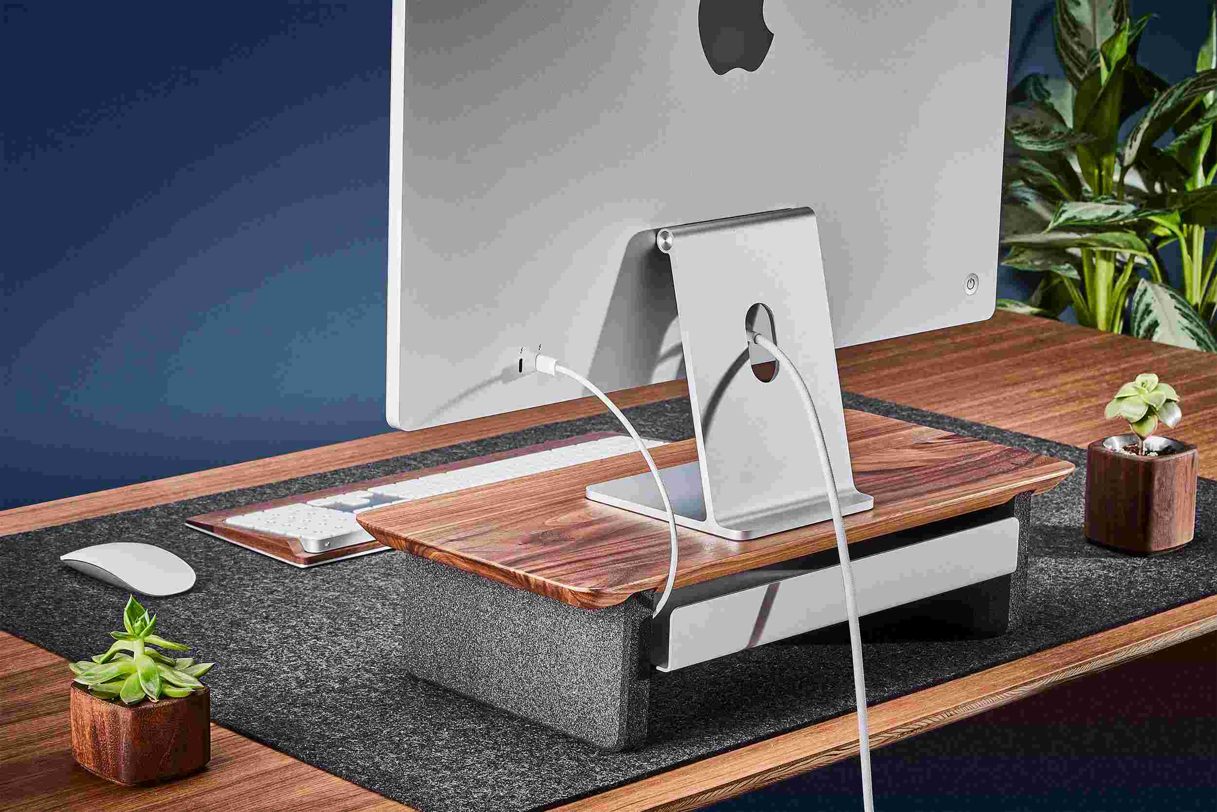 Rear view of the small hardwood walnut monitor organizer showing the back edge of the bent metal shelf, designed to keep your stuff in place, while leaving space for hidden cord access.