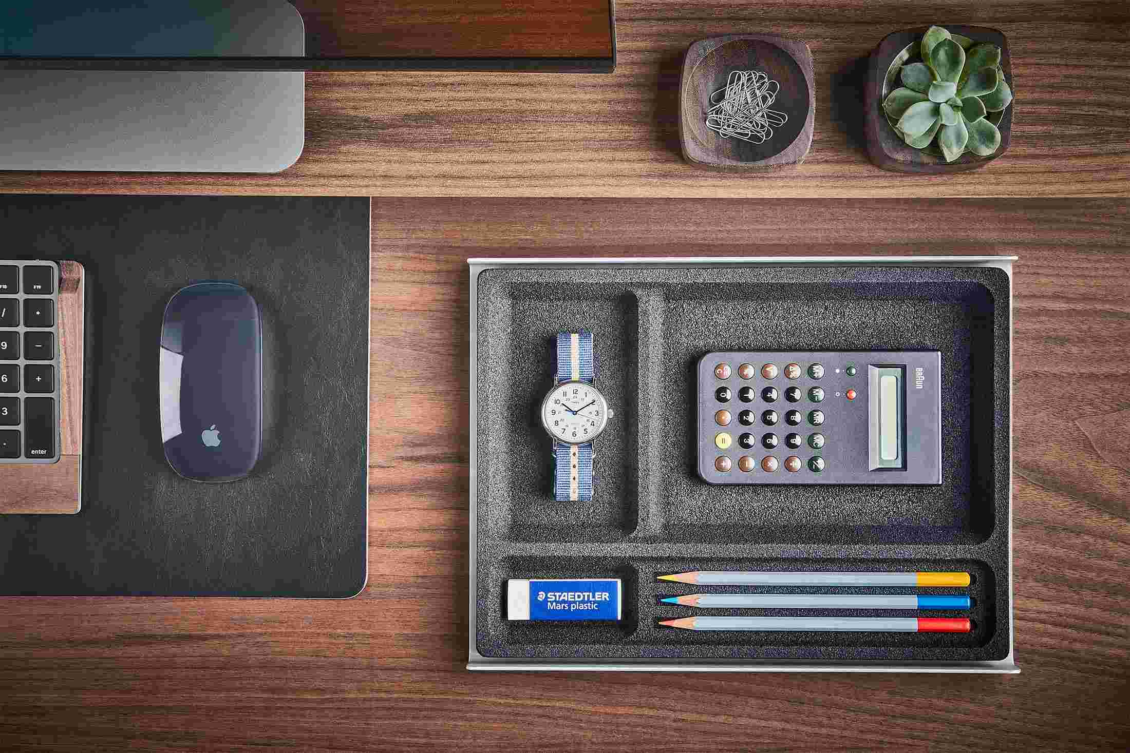 The Dark Cork Desk Tray containing common tools and writing utensils for fast access.