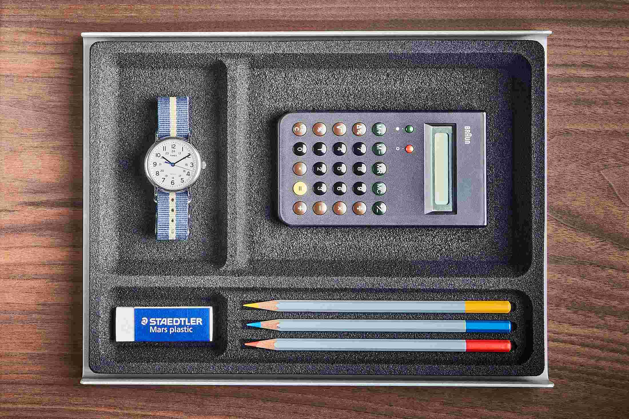 The Dark Cork Desk Tray containing common tools and writing utensils for fast access.