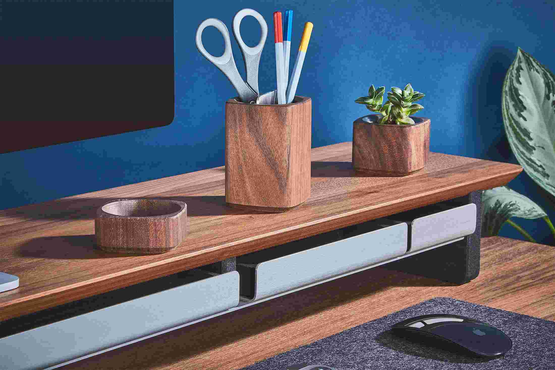 All three sizes of dark desk tray pushed in flush into the walnut desk shelf's metal recess.
