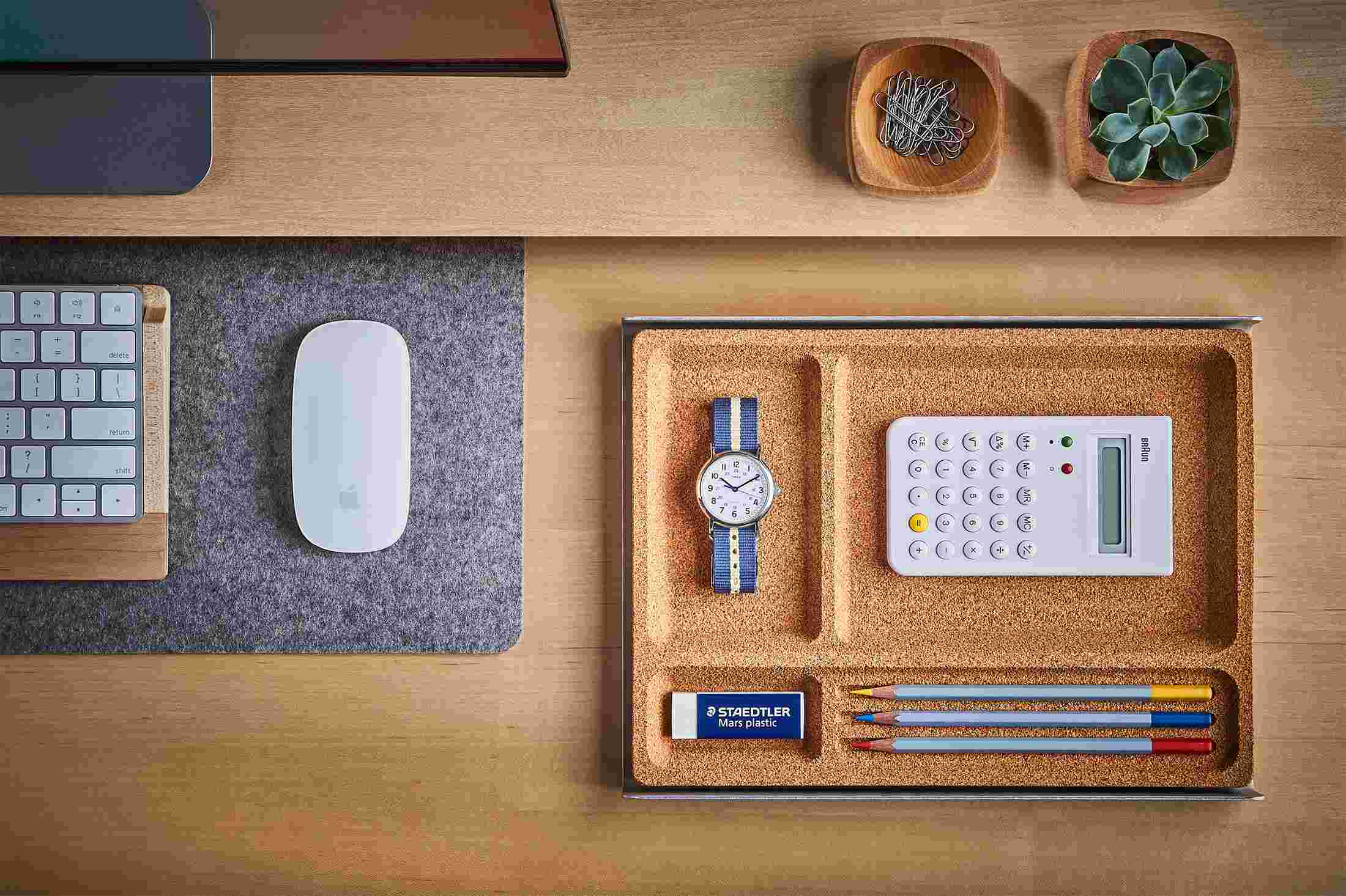 The Light Cork Desk Tray containing common tools and writing utensils for fast access.