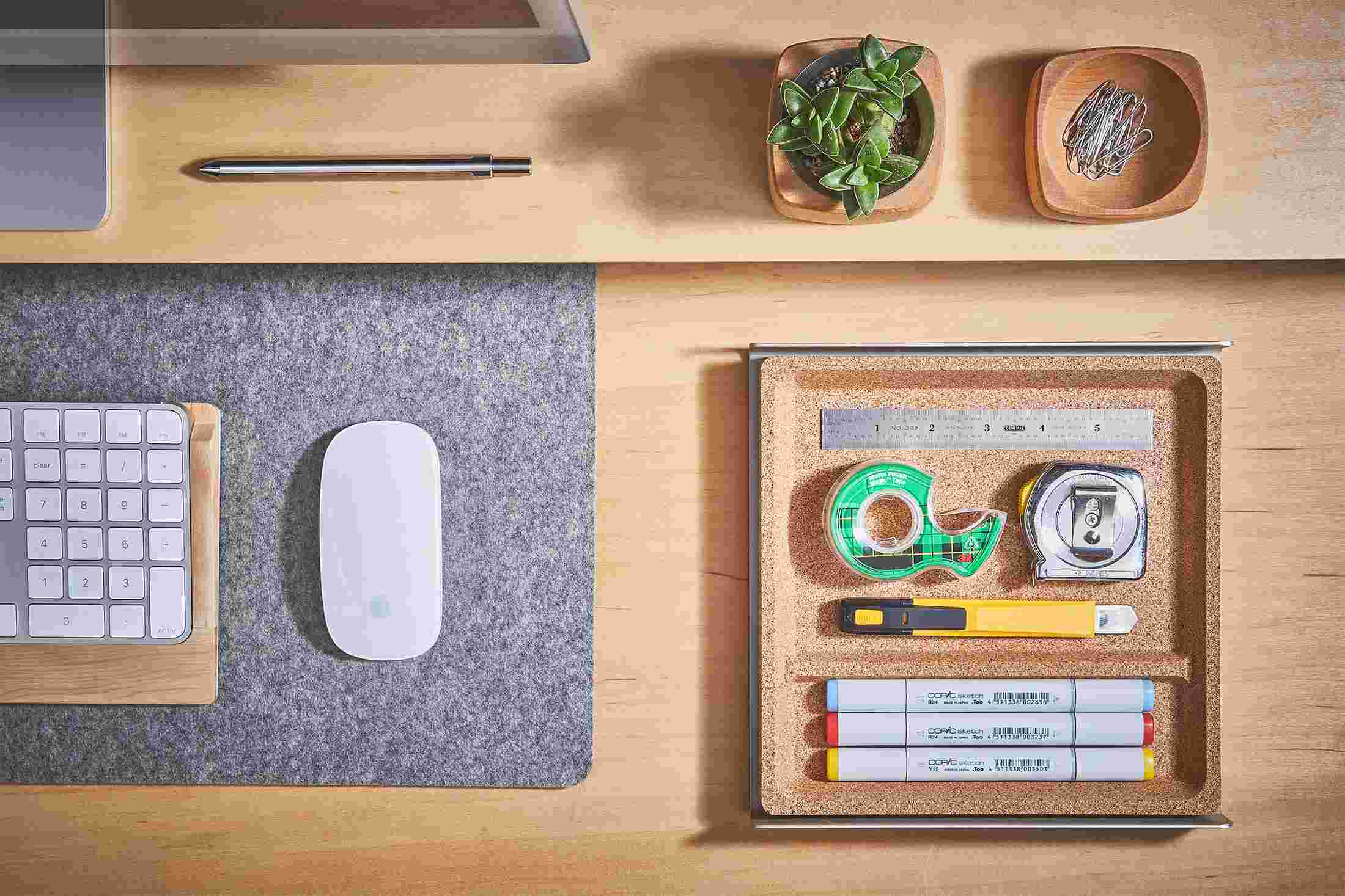 Overhead view of the medium light cork desk tray holding office supplies.