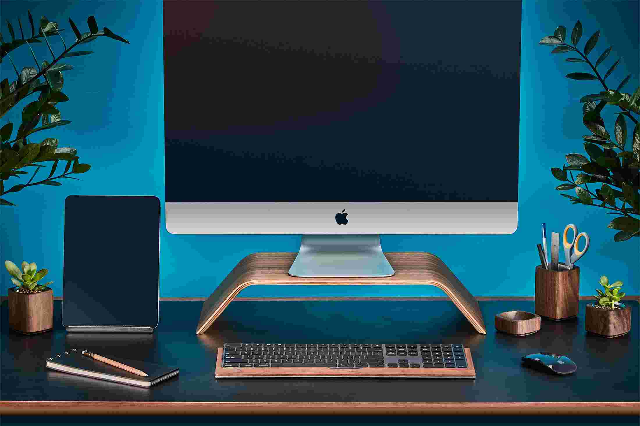 Walnut wood desk collection, including bent wood monitor stand and wood iPad stand.