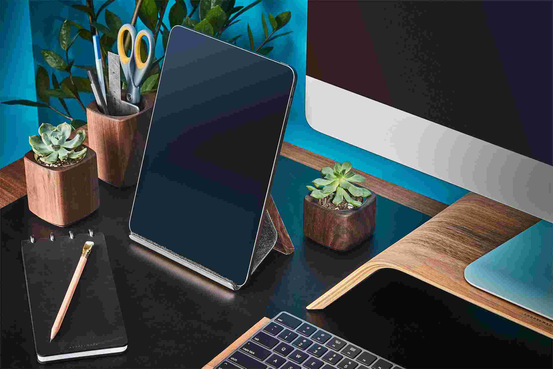 Walnut wood iPad Stand with wood pen cup and succulent planters.