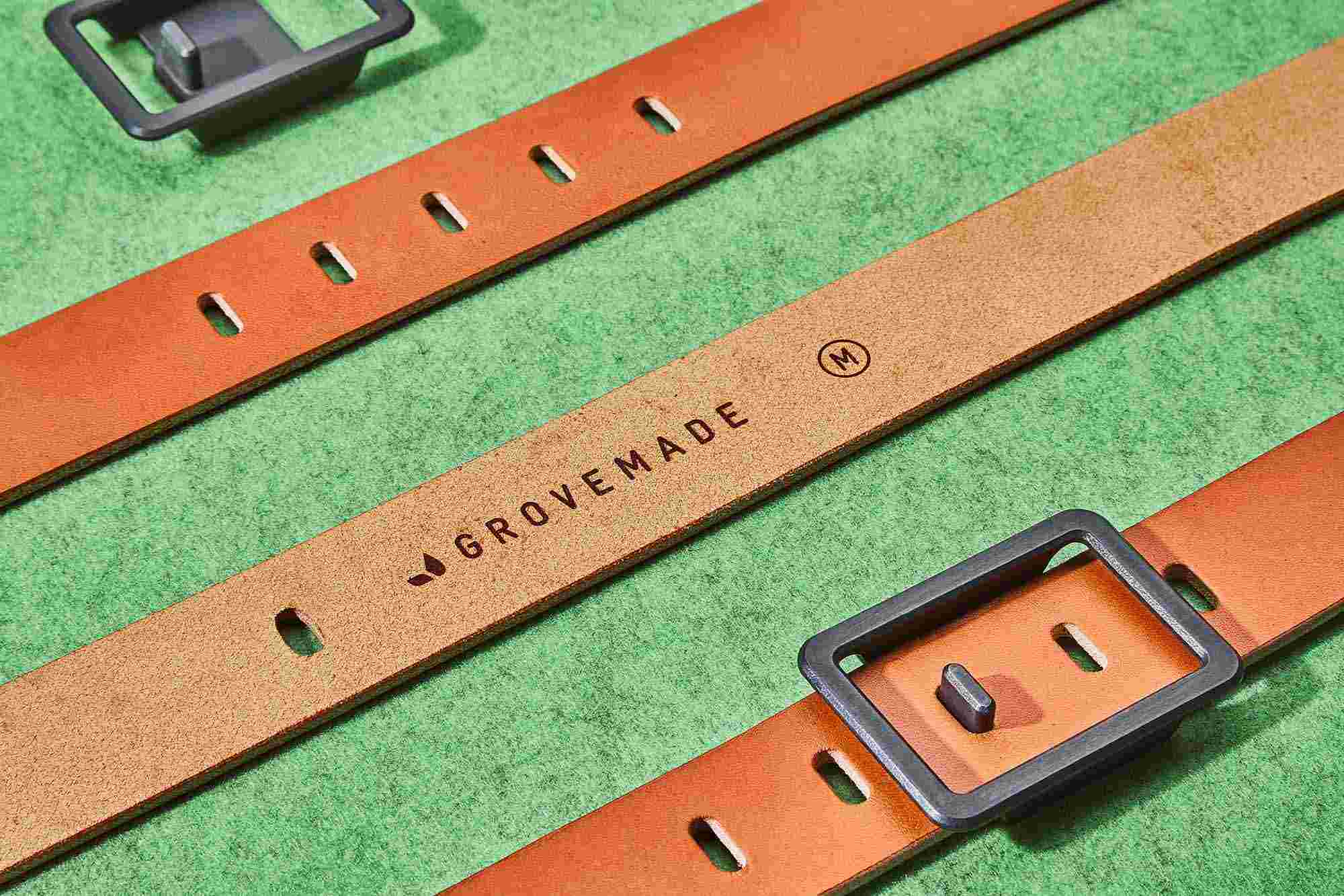 Engraving detail of Grovemade logo and size information on the inside of the minimalist belt.