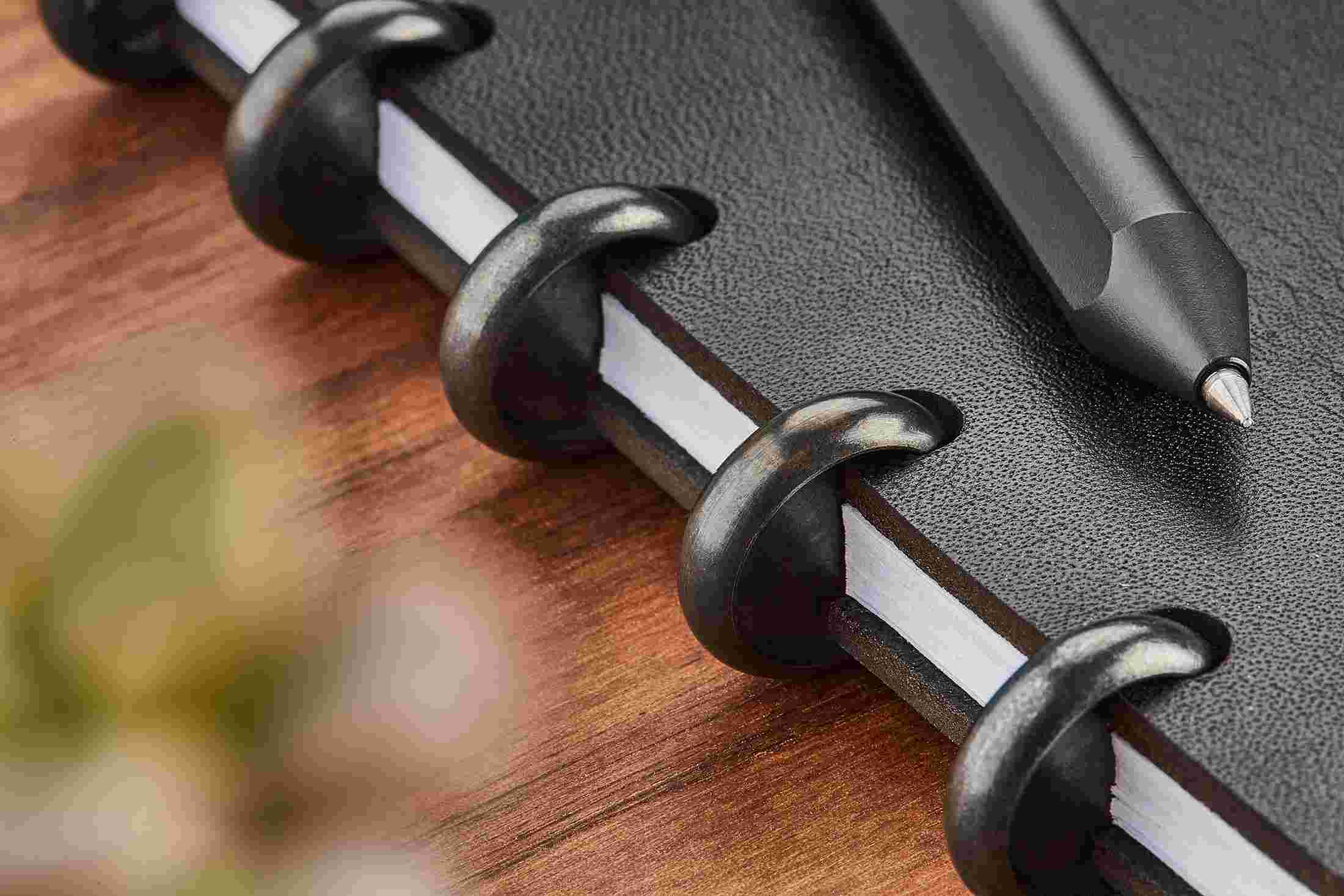 Detail of the black discs on the Grovemade Premium Black Leather Discbound Notebook.