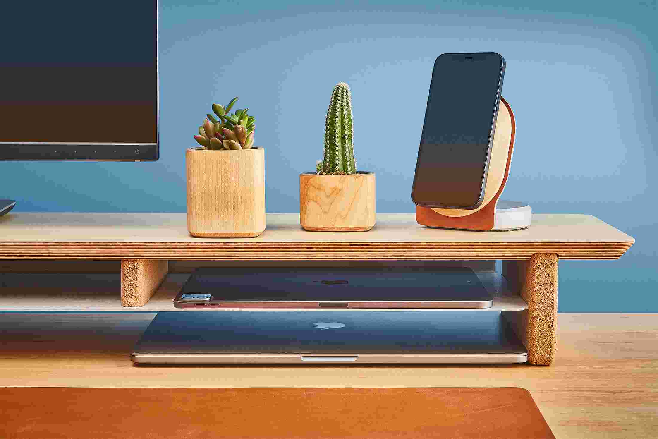 The desk shelf's integrated storage shelf holding both a 12.9 inch iPad Pro and 9.7 inch iPad.