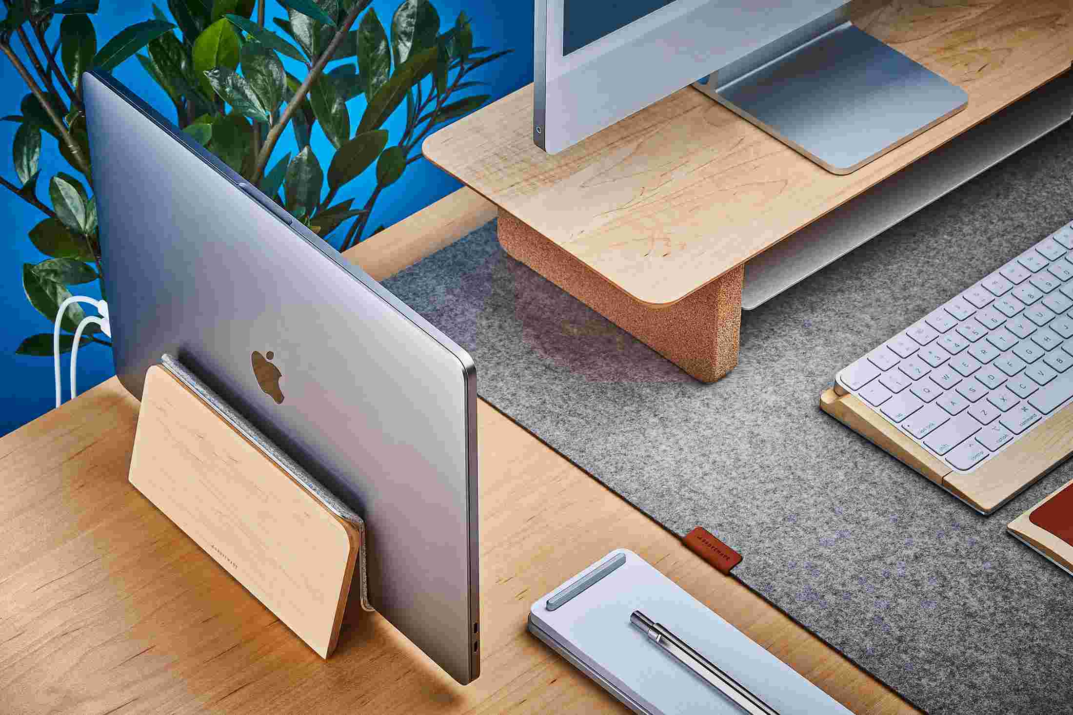 The Grovemade MacBook Dock in solid maple hardwood for vertical laptop storage.