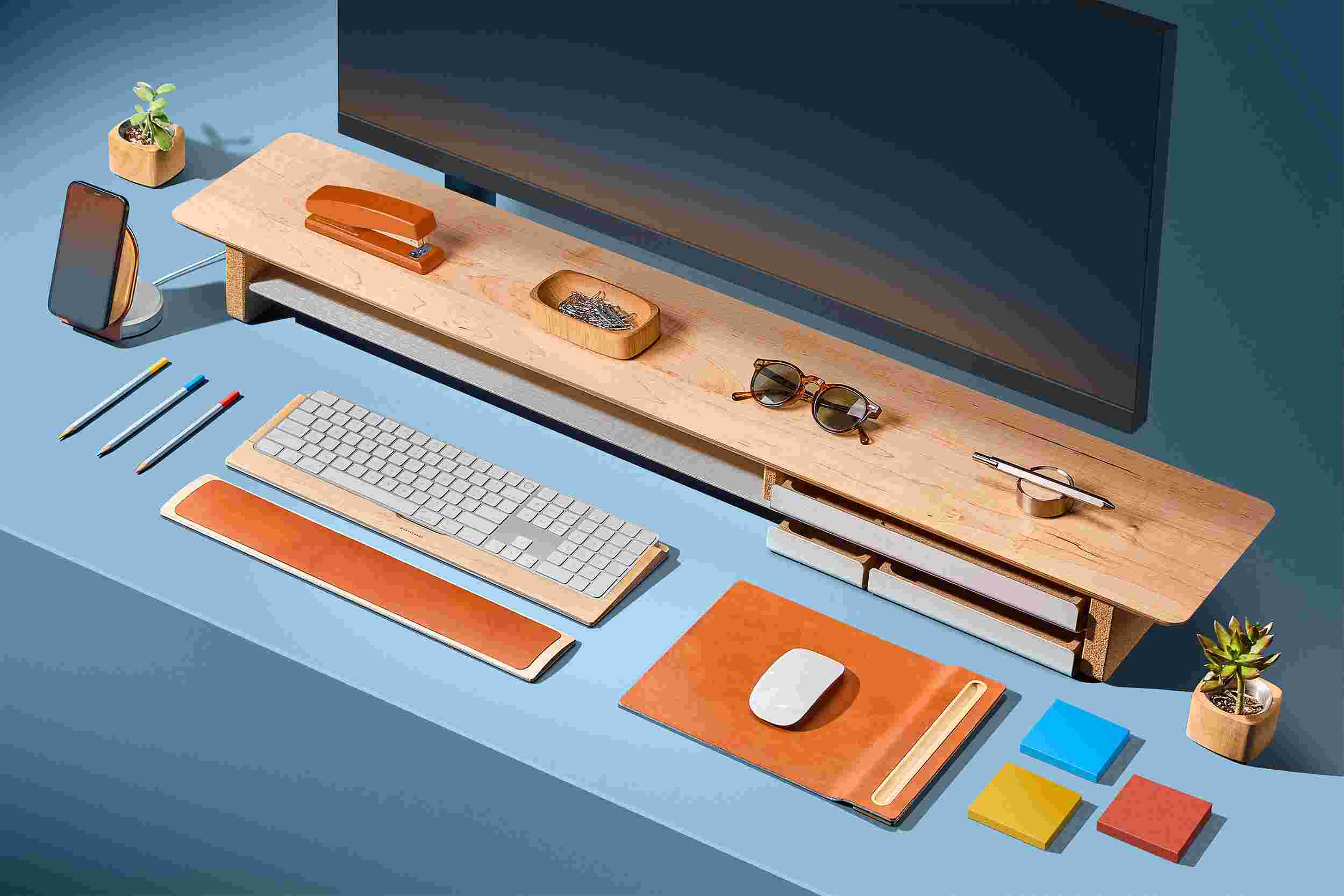 Large walnut desk shelf on bright blue background with matching wood accessories.