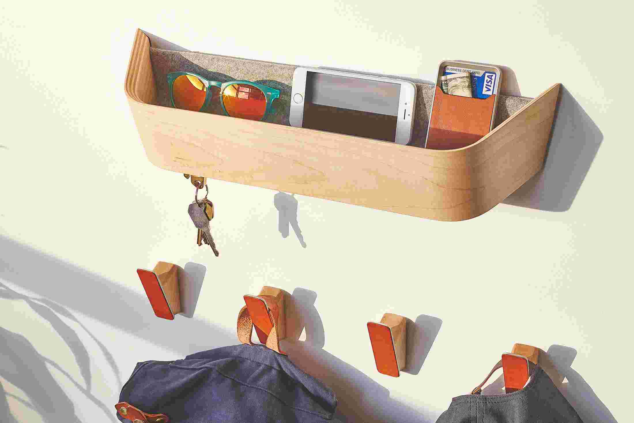 The maple catch-all housing sunglasses, iPhone, and minimalist wallet.