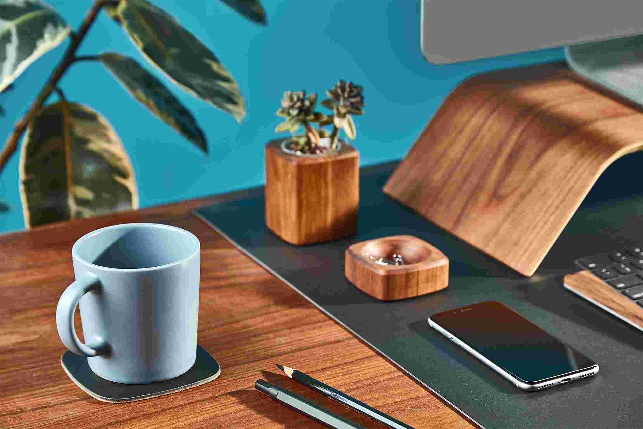 The matte black coaster matching the Grovemade Matte Black Desk Pad.