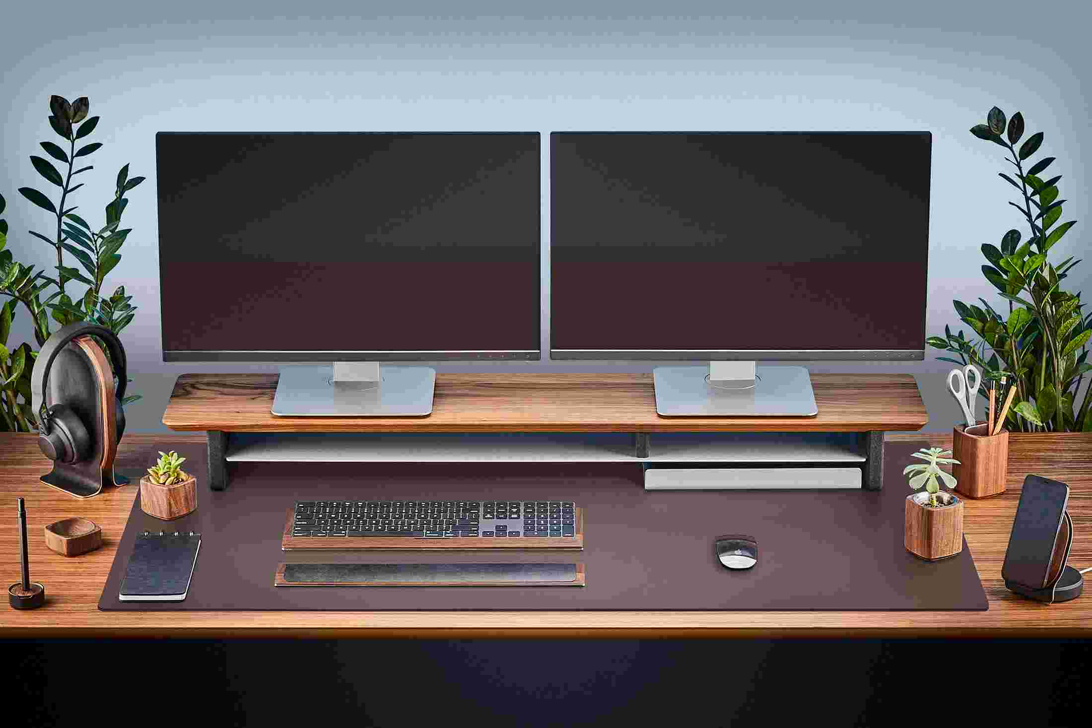 The Extra Large Matte Desk Pad in Brown covering almost an entire desktop, in use with the Walnut Desk Shelf System.